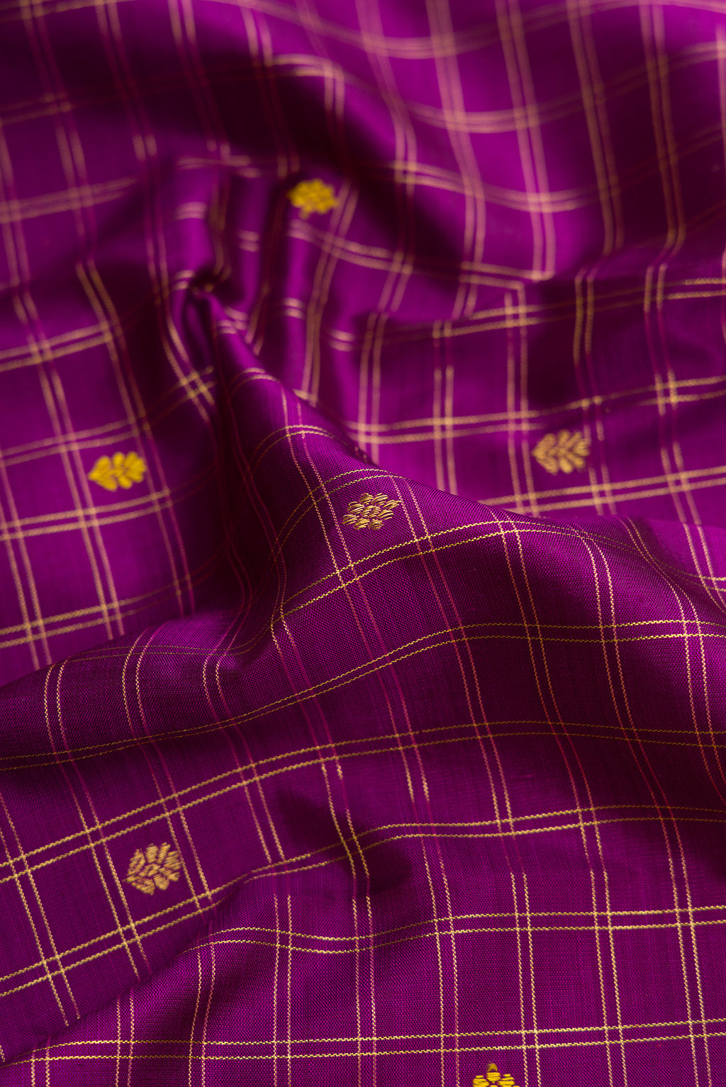 Close up of Purple Dual Tone Kanjivaram Silk Saree with Zari And Thread Butta on the body and Zari Border.  displaying folds