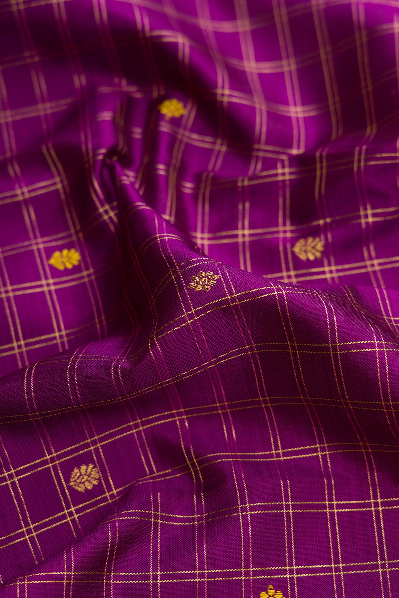 Close up of Purple Dual Tone Kanjivaram Silk Saree with Zari And Thread Butta on the body and Zari Border.  displaying folds