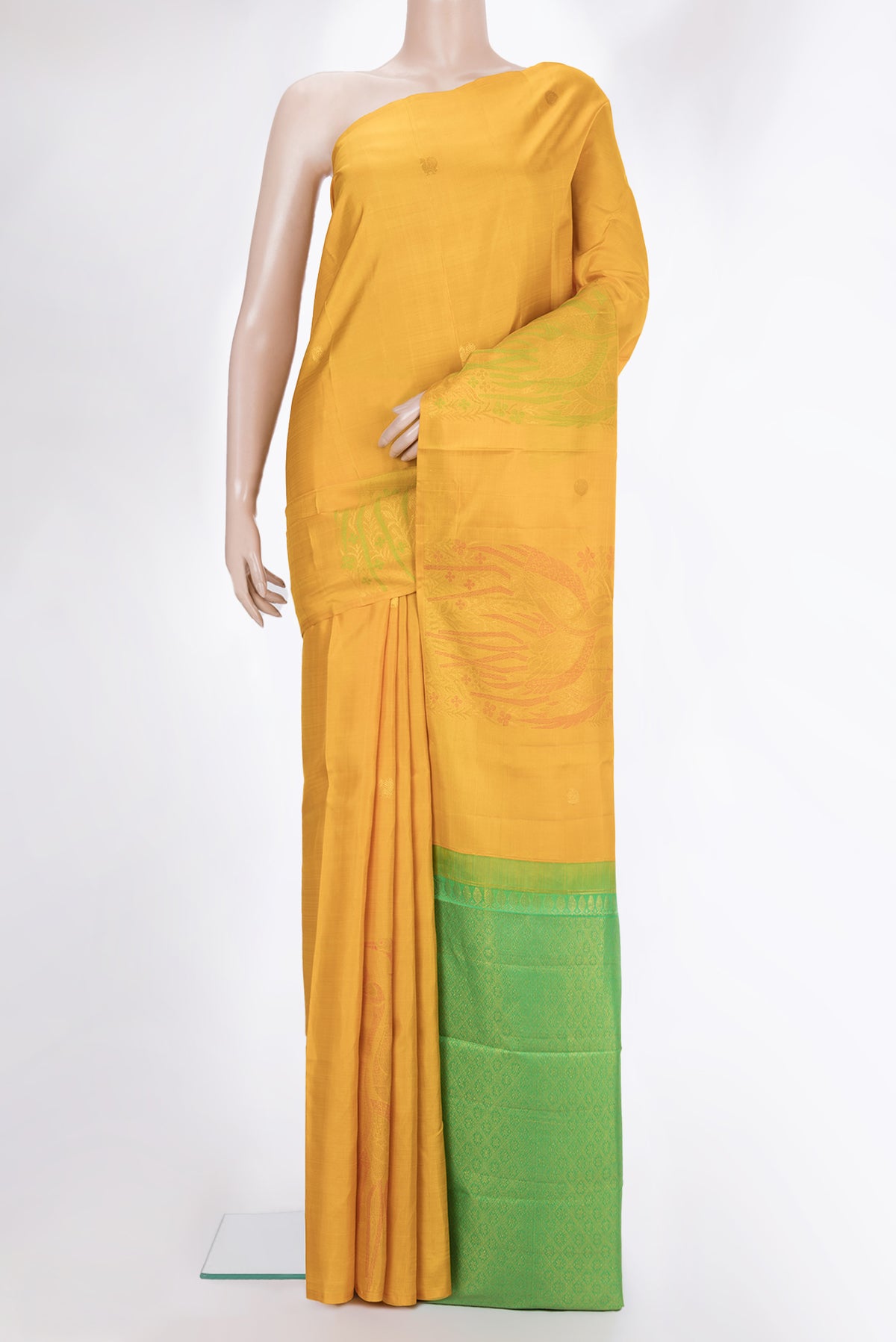Pure Silk Mustard Dual Tone Kanjivaram Saree with Zari And Thread Butta on the body and Without Border.  displayed on a mannequin