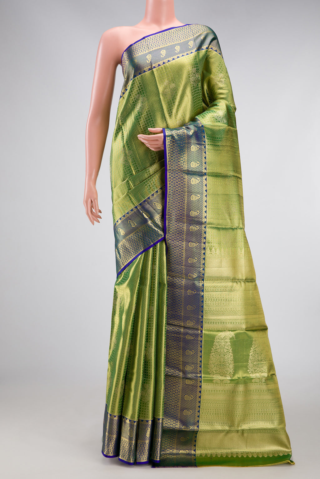 Parrot Green Dual Tone Kanchipuram Tissue Silk Saree with Zari Brocade on the body and Zari Border.  displayed on a mannequin