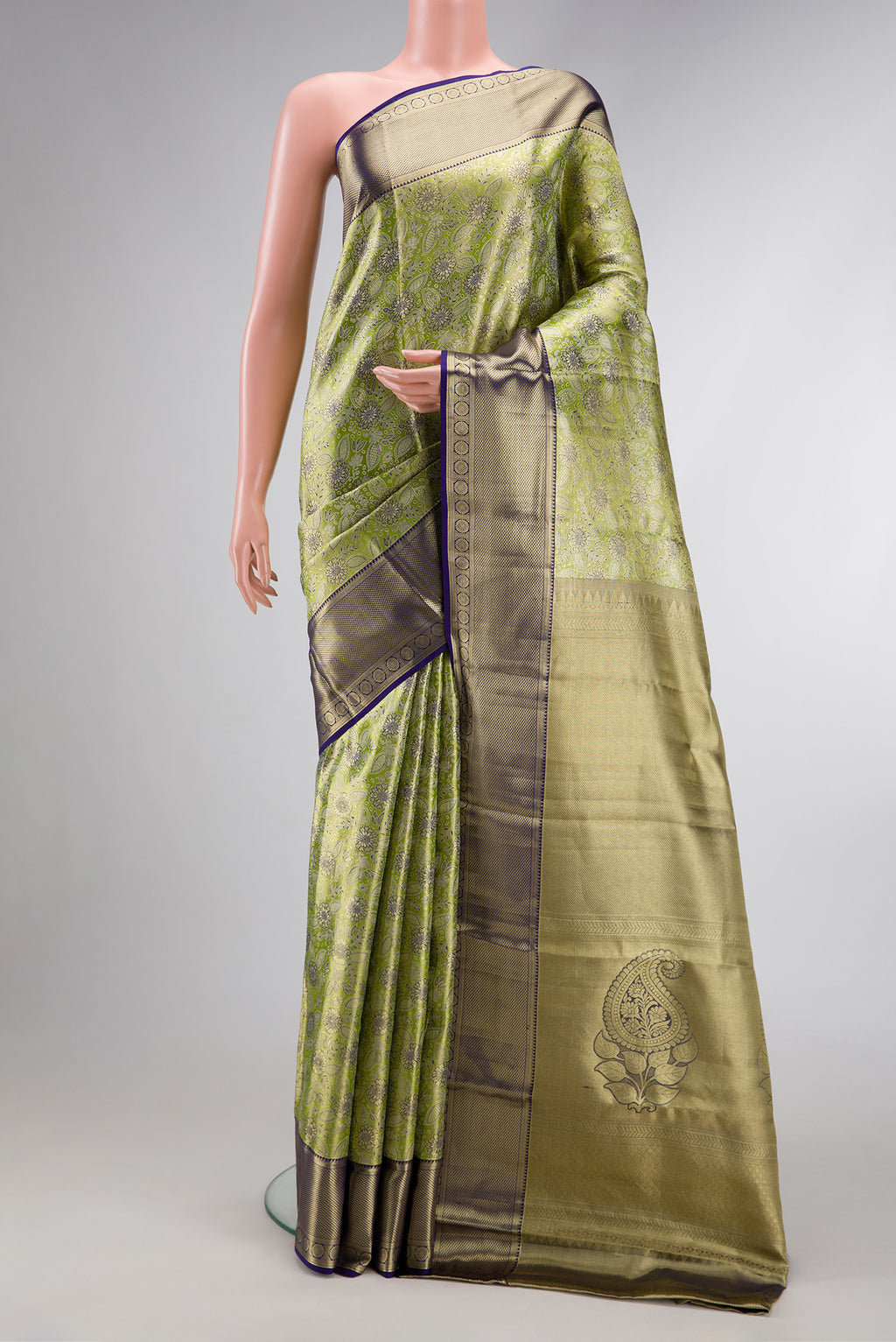Pista Green Dual Tone Kanchipuram Tissue Silk Saree with Zari Brocade on the body and Zari Border.  displayed on a mannequin