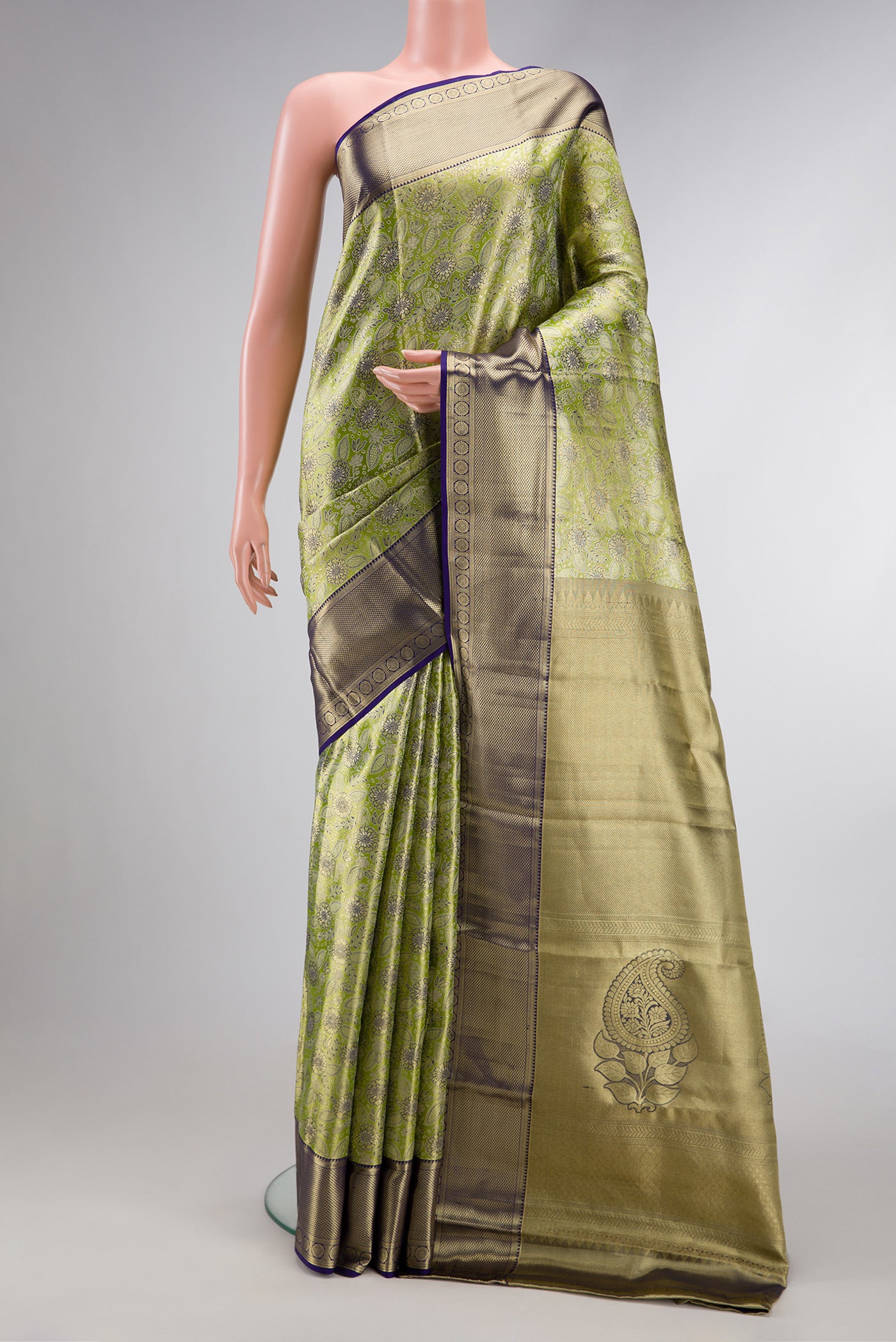 Pista Green Dual Tone Kanchipuram Tissue Silk Saree with Zari Brocade on the body and Zari Border.  displayed on a mannequin