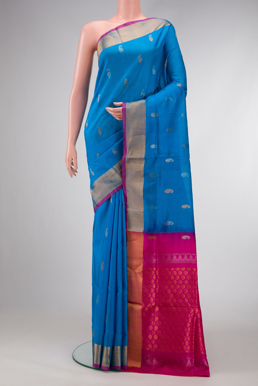 Peacock Blue Dual Tone Uppada Silk Saree with Zari Butta on the body and Zari Border.  displayed on a mannequin
