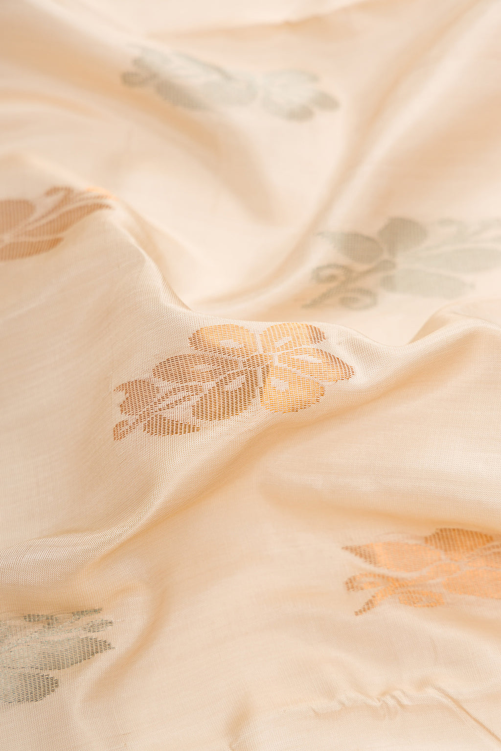 Close up of Dark Beige Dual Tone Uppada Silk Saree with Zari Butta on the body and Zari Border.  displaying folds