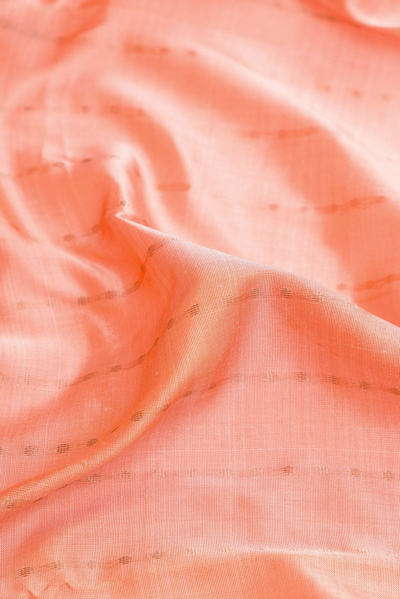 Close up of Peach Dual Tone Uppada Silk Saree with Stripes on the body and Zari Border.  displaying folds