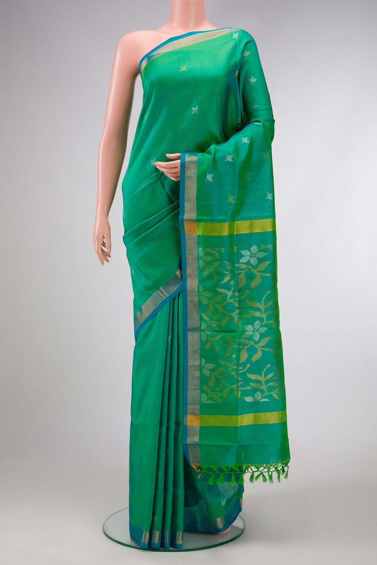 Green Dual Tone Uppada Silk Saree with Zari Butta on the body and Zari Border.  displayed on a mannequin