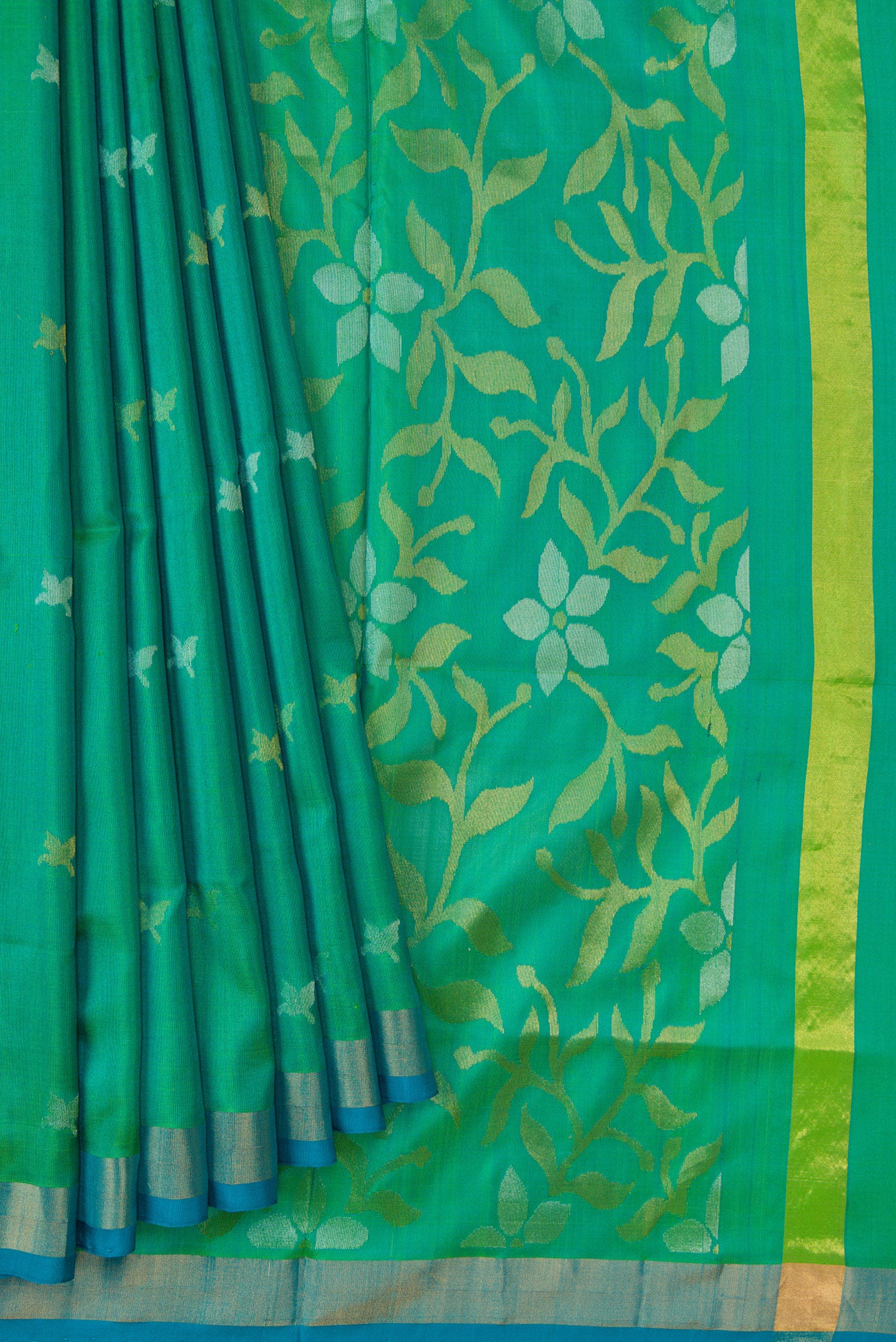 Pleats and pallu of Green Dual Tone Uppada Silk Saree with Zari Butta on the body and Zari Border. 