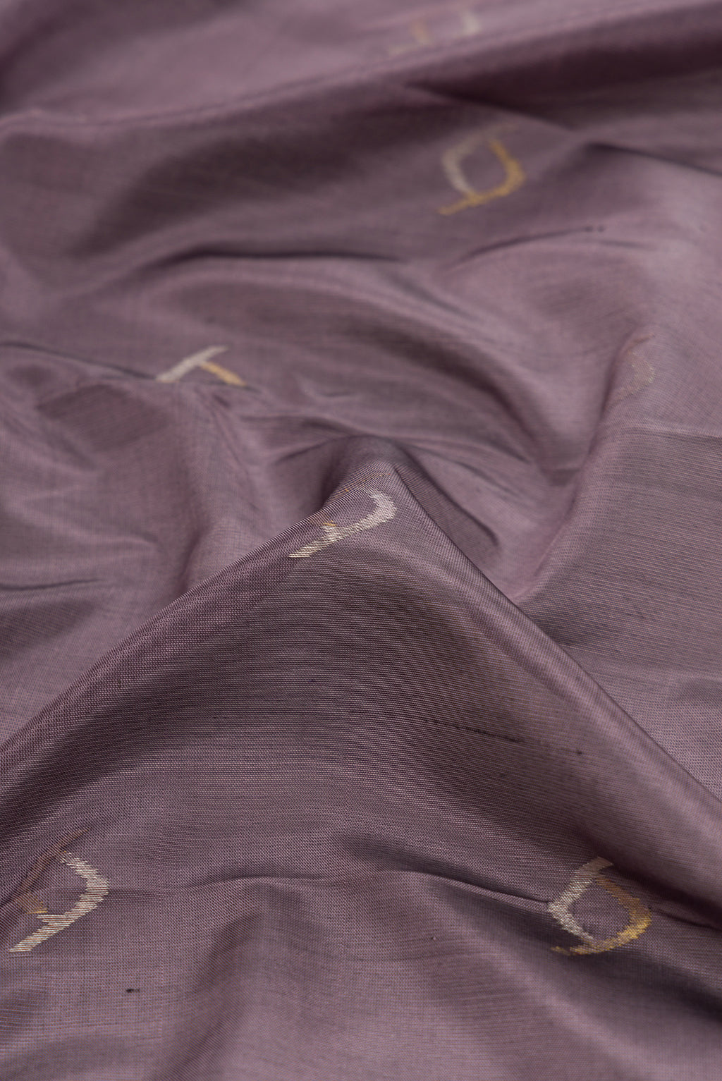 Close up of Lavender Dual Tone Soft Silk Saree with Zari Butta on the body and Zari Border.  displaying folds