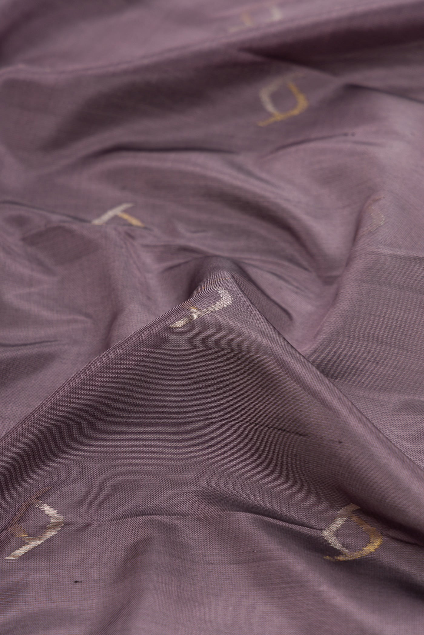 Close up of Lavender Dual Tone Soft Silk Saree with Zari Butta on the body and Zari Border.  displaying folds