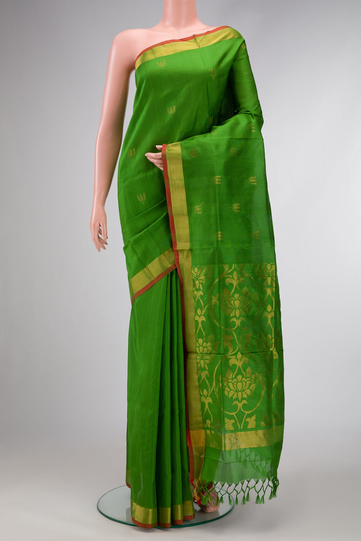 Green Dual Tone Soft Silk Saree with Zari Butta on the body and Zari Border.  displayed on a mannequin