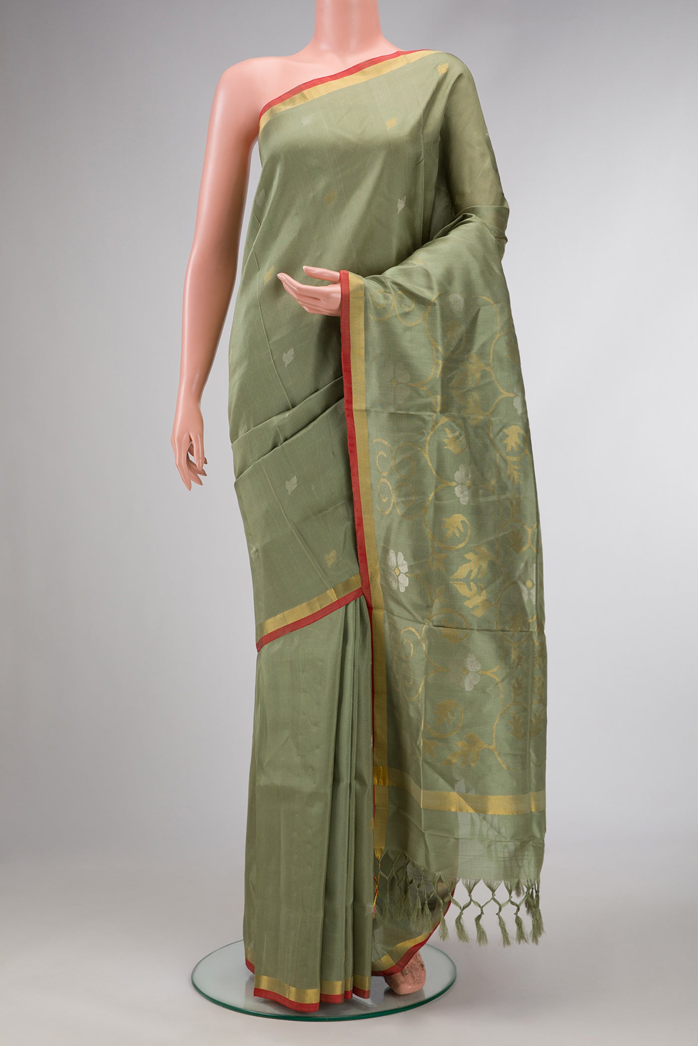 Light Green Dual Tone Soft Silk Saree with Zari Butta on the body and Zari Border.  displayed on a mannequin