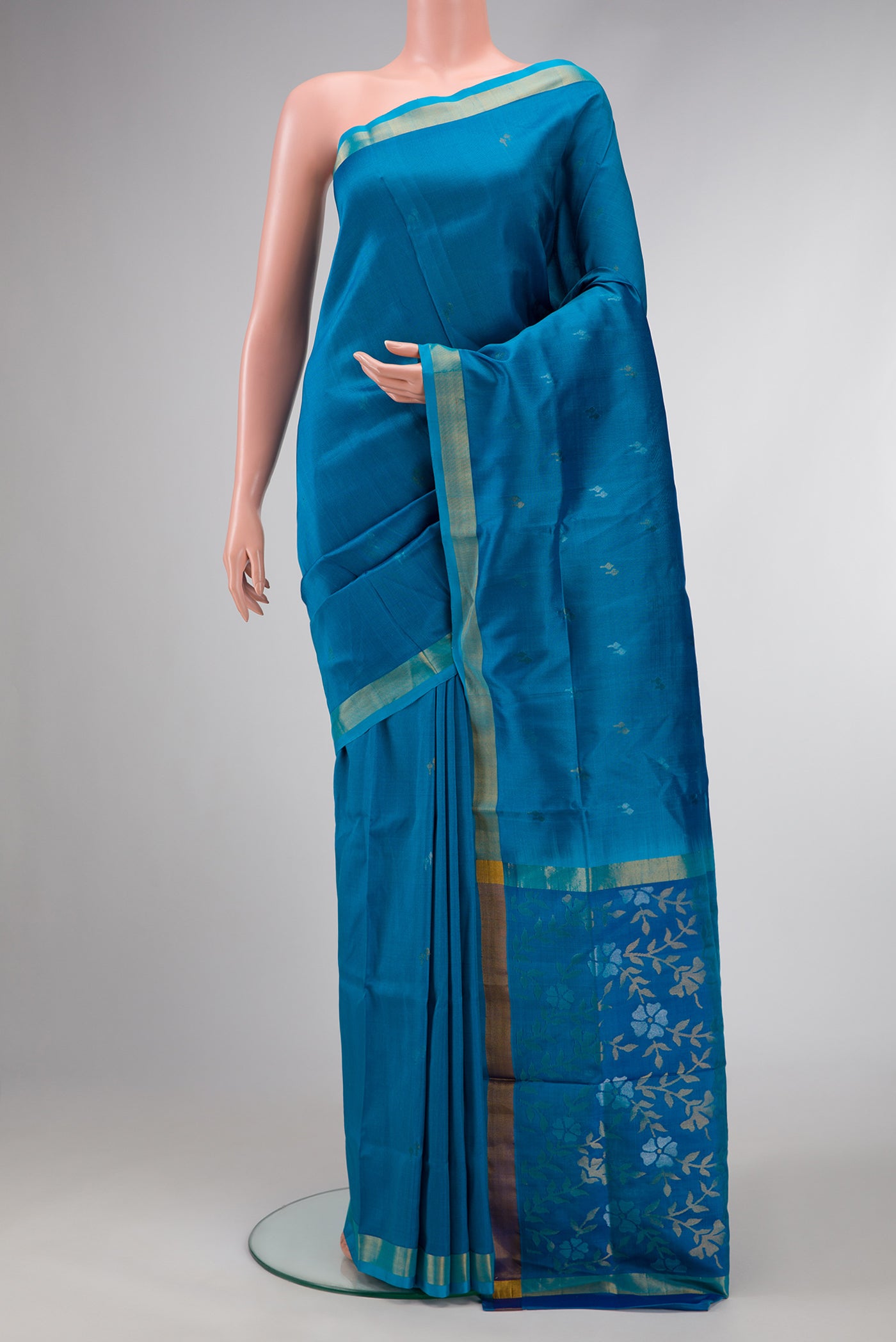 Sky Blue Dual Tone Soft Silk Saree with Zari Butta on the body and Zari Border.  displayed on a mannequin