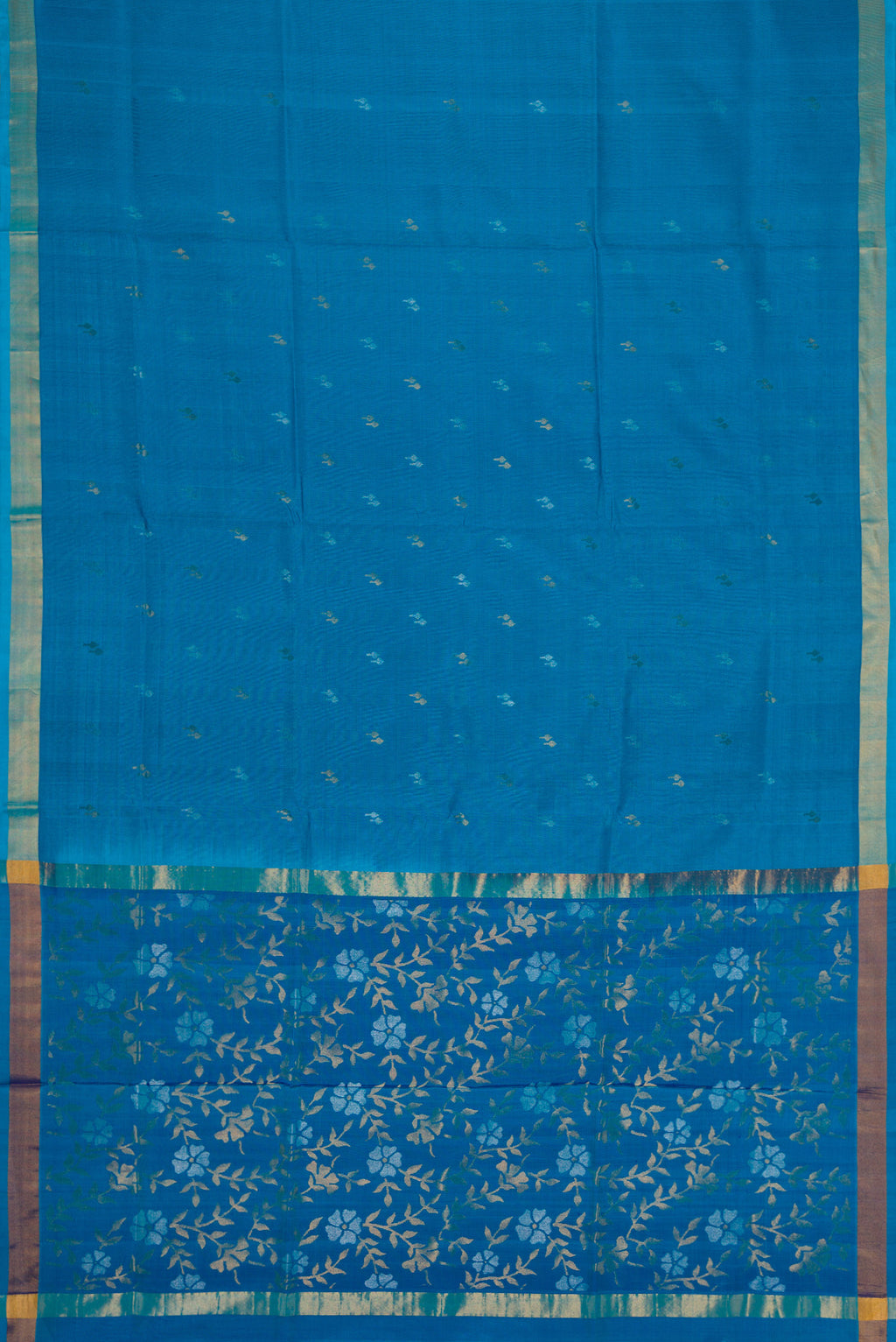 Flat view of Sky Blue Dual Tone Soft Silk Saree with Zari Butta on the body and Zari Border. 