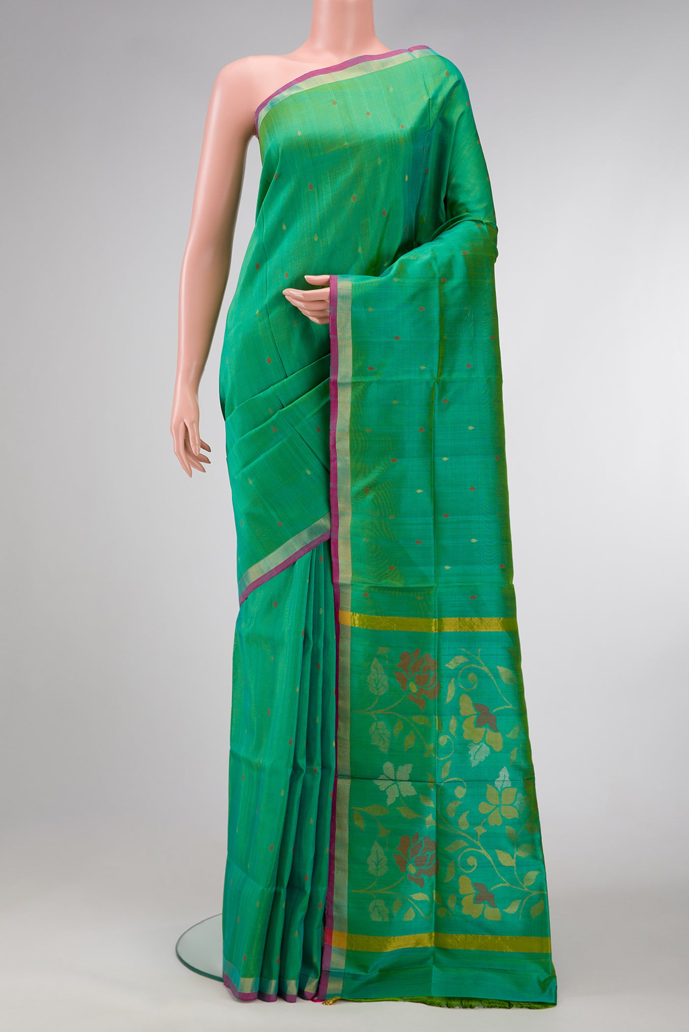 Green Dual Tone Uppada Silk Saree with Zari Butta on the body and Zari Border.  displayed on a mannequin