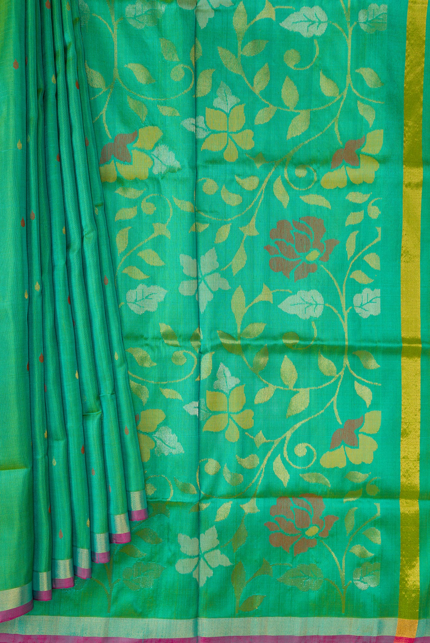 Pleats and pallu of Green Dual Tone Uppada Silk Saree with Zari Butta on the body and Zari Border. 