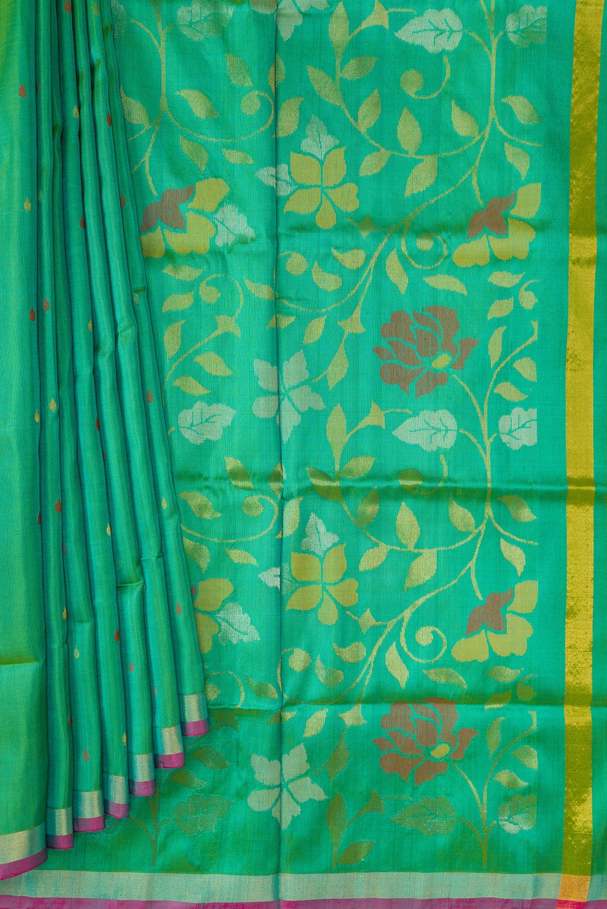 Pleats and pallu of Green Dual Tone Uppada Silk Saree with Zari Butta on the body and Zari Border. 