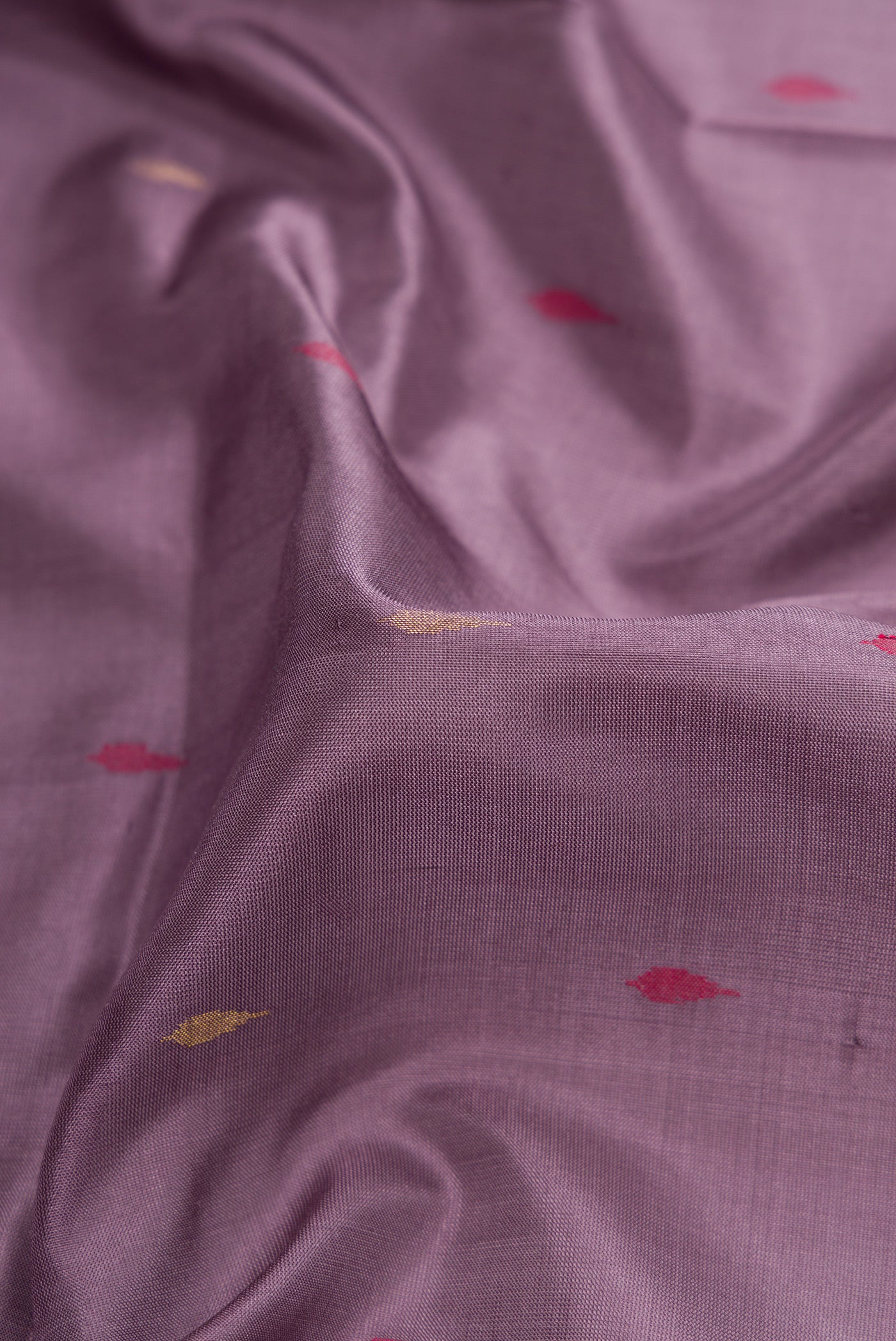 Close up of Purple Dual Tone Uppada Silk Saree with Zari And Thread Butta on the body and Zari Border.  displaying folds