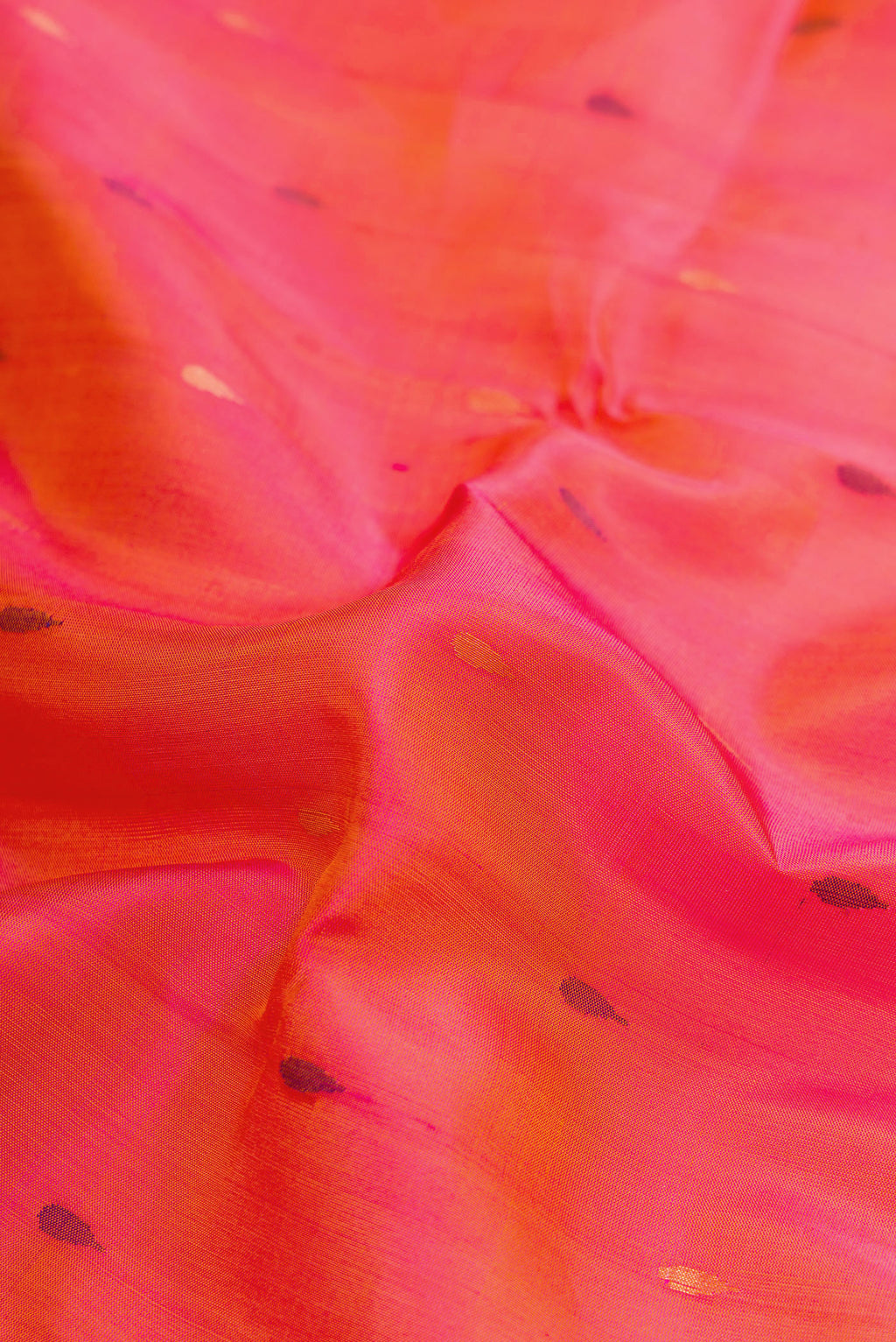 Close up of Coral Dual Tone Uppada Silk Saree with Zari And Thread Butta on the body and Zari Border.  displaying folds