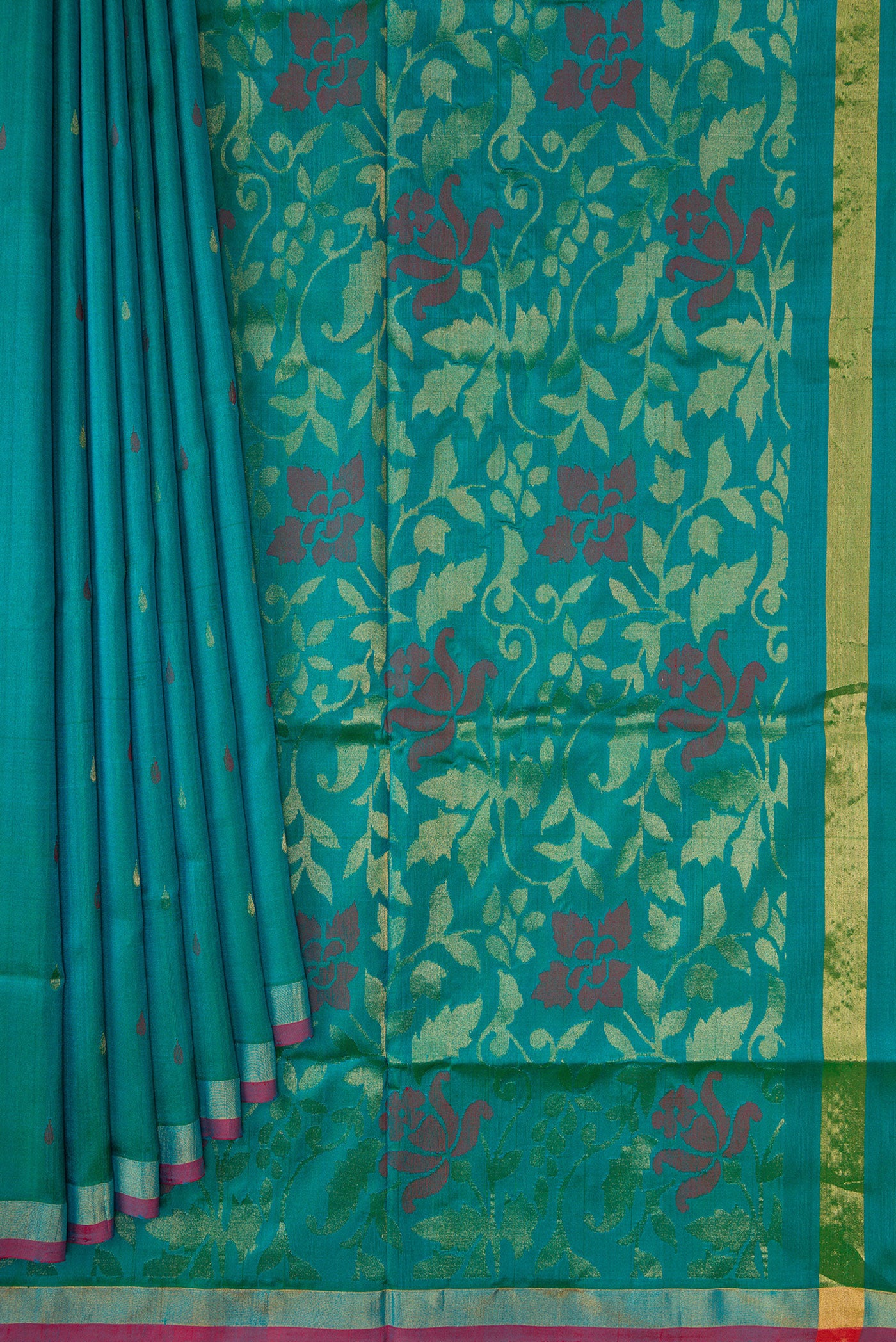 Pleats and pallu of Peacock Blue Dual Tone Uppada Silk Saree with Zari And Thread Butta on the body and Zari Border. 