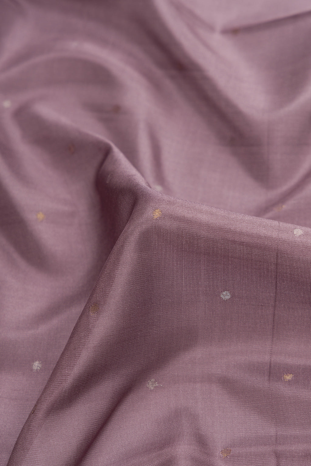 Close up of Lavender Dual Tone Uppada Silk Saree with Zari Butta on the body and Zari Border.  displaying folds