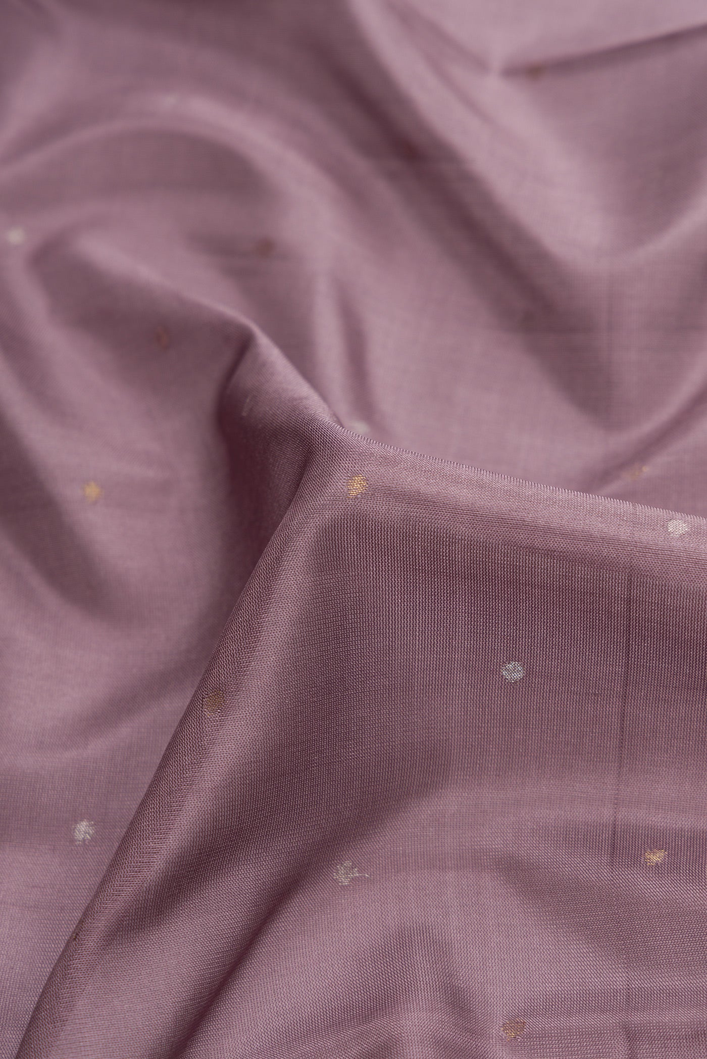 Close up of Lavender Dual Tone Uppada Silk Saree with Zari Butta on the body and Zari Border.  displaying folds