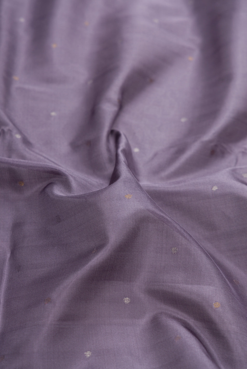 Close up of Grey Dual Tone Uppada Silk Saree with Zari Butta on the body and Zari Border.  displaying folds