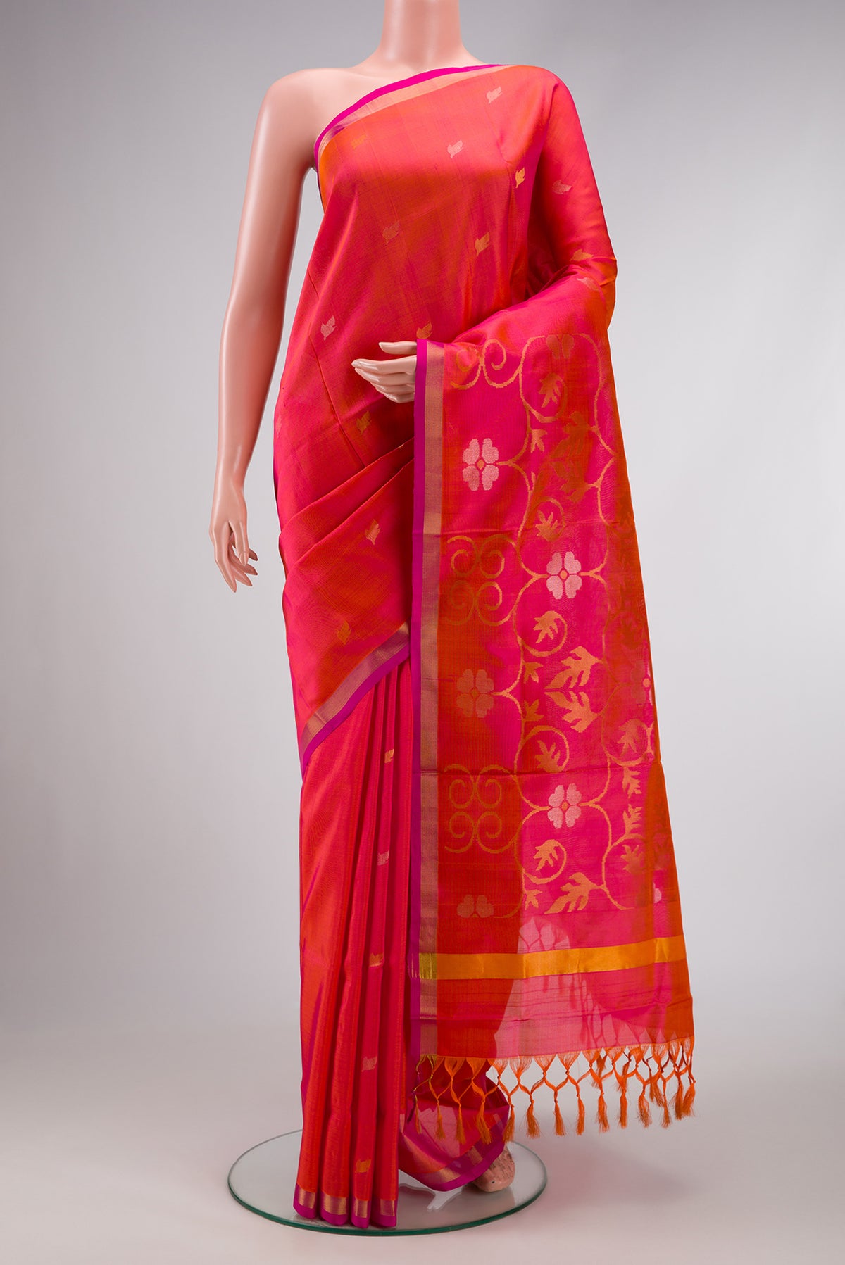 Coral Dual Tone Uppada Silk Saree with Zari Butta on the body and Zari Border.  displayed on a mannequin