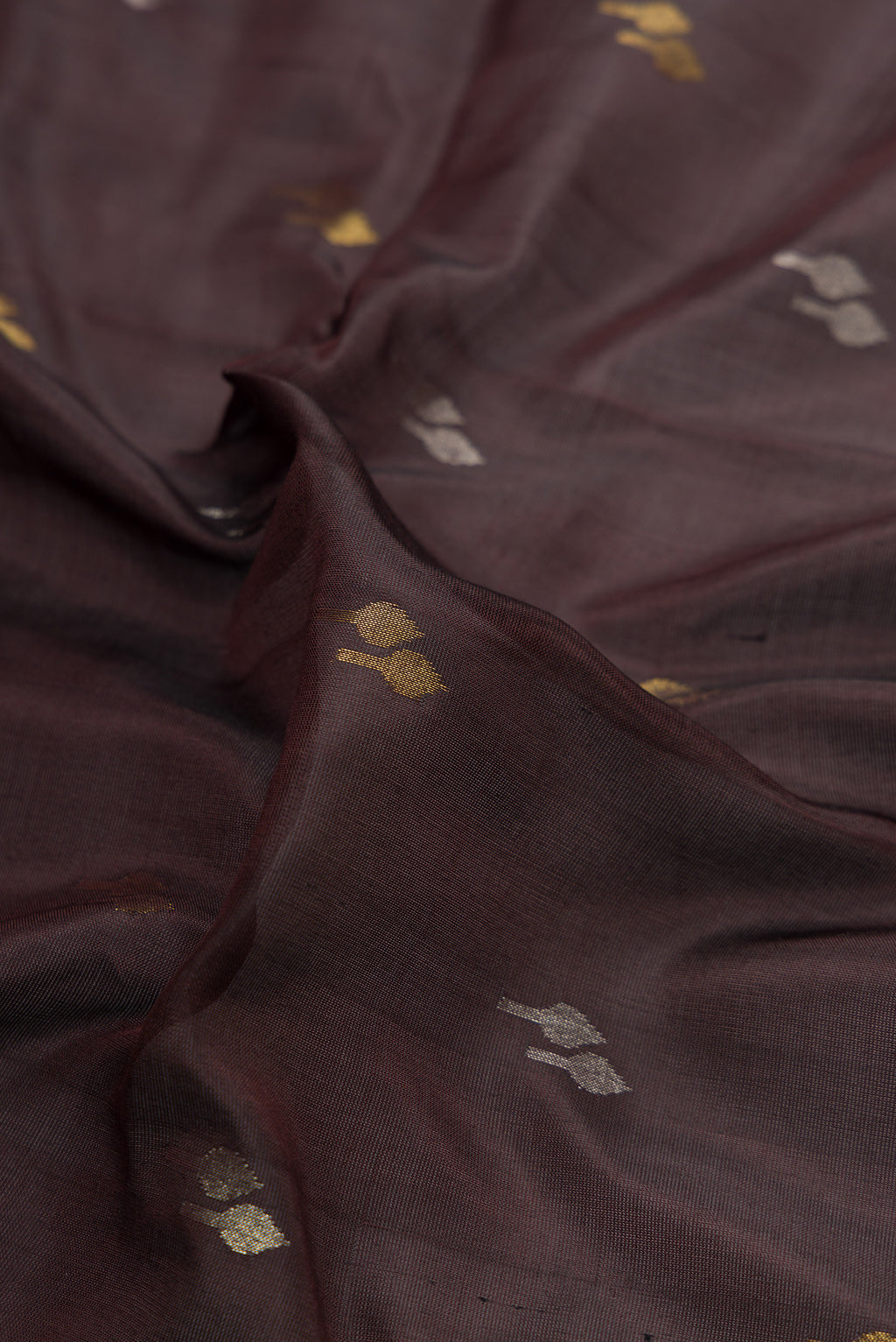 Close up of Coffee Brown Dual Tone Uppada Silk Saree with Zari Butta on the body and Zari Border.  displaying folds