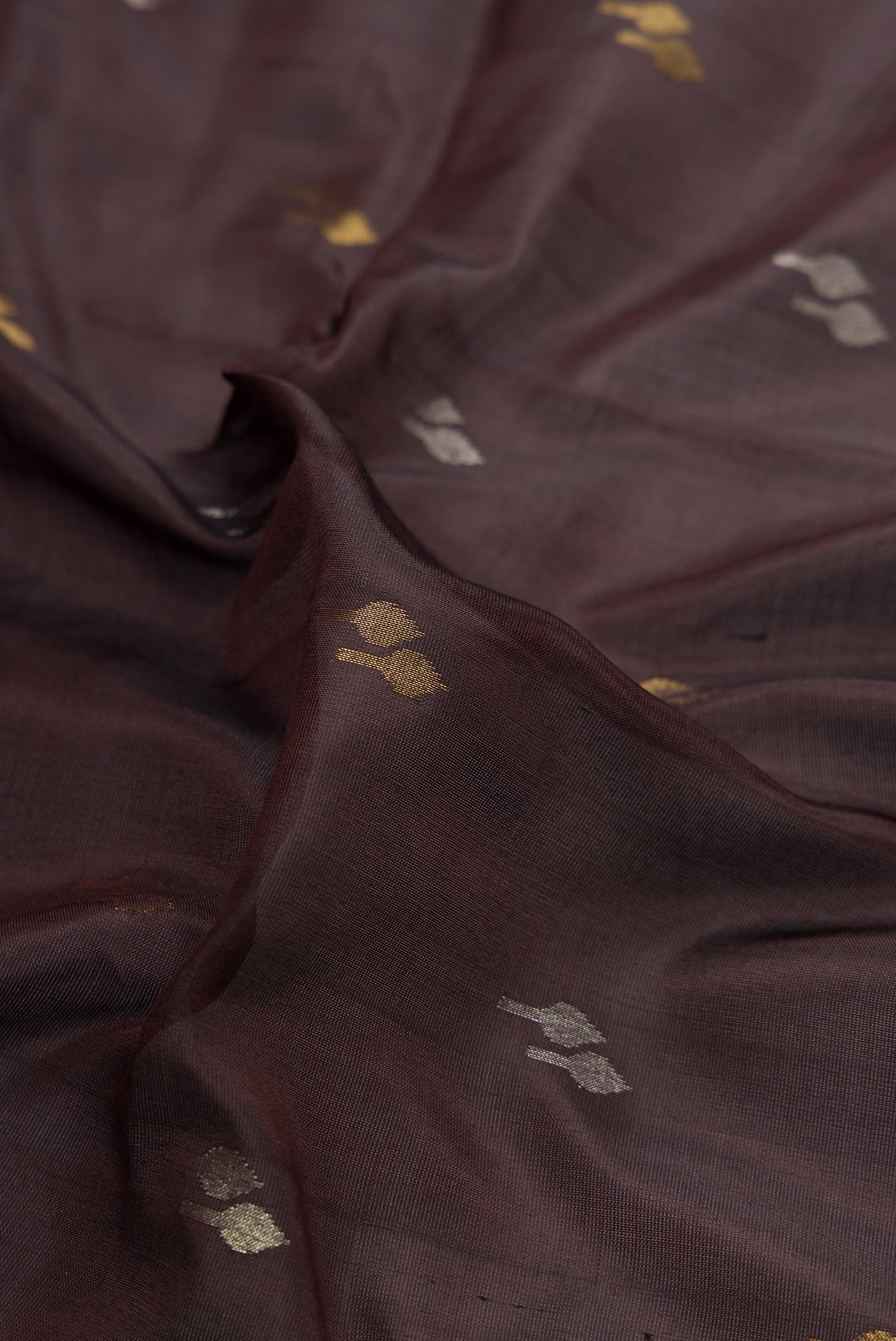 Close up of Coffee Brown Dual Tone Uppada Silk Saree with Zari Butta on the body and Zari Border.  displaying folds