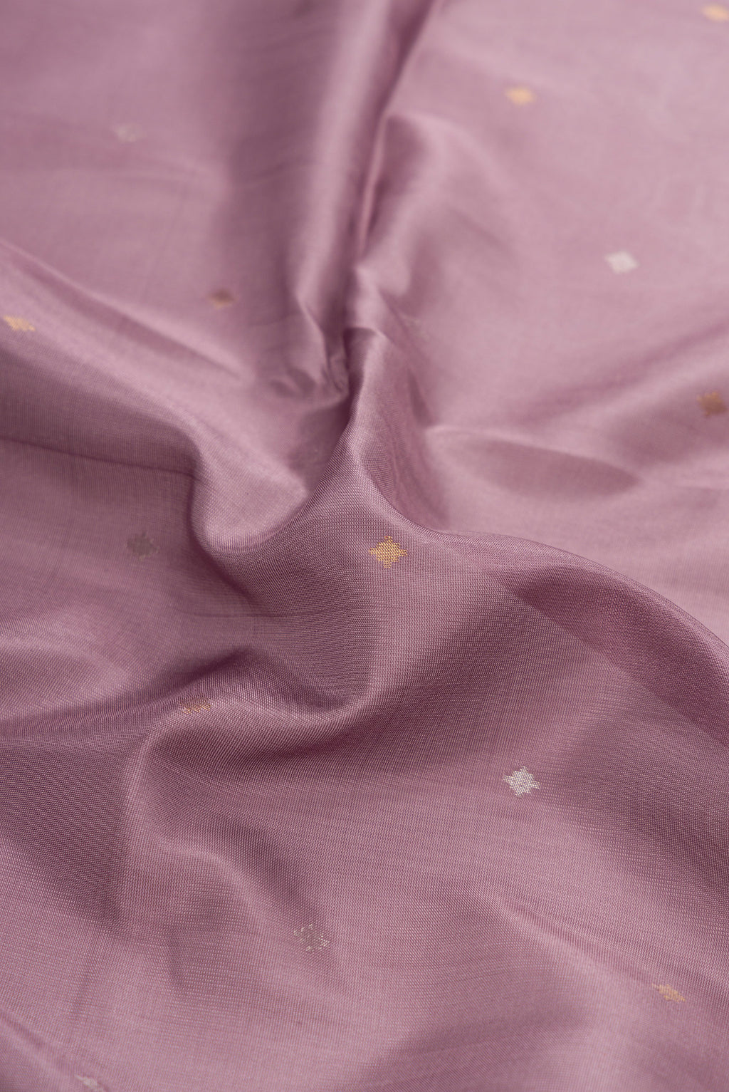 Close up of Brown Dual Tone Uppada Silk Saree with Zari Butta on the body and Zari Border.  displaying folds