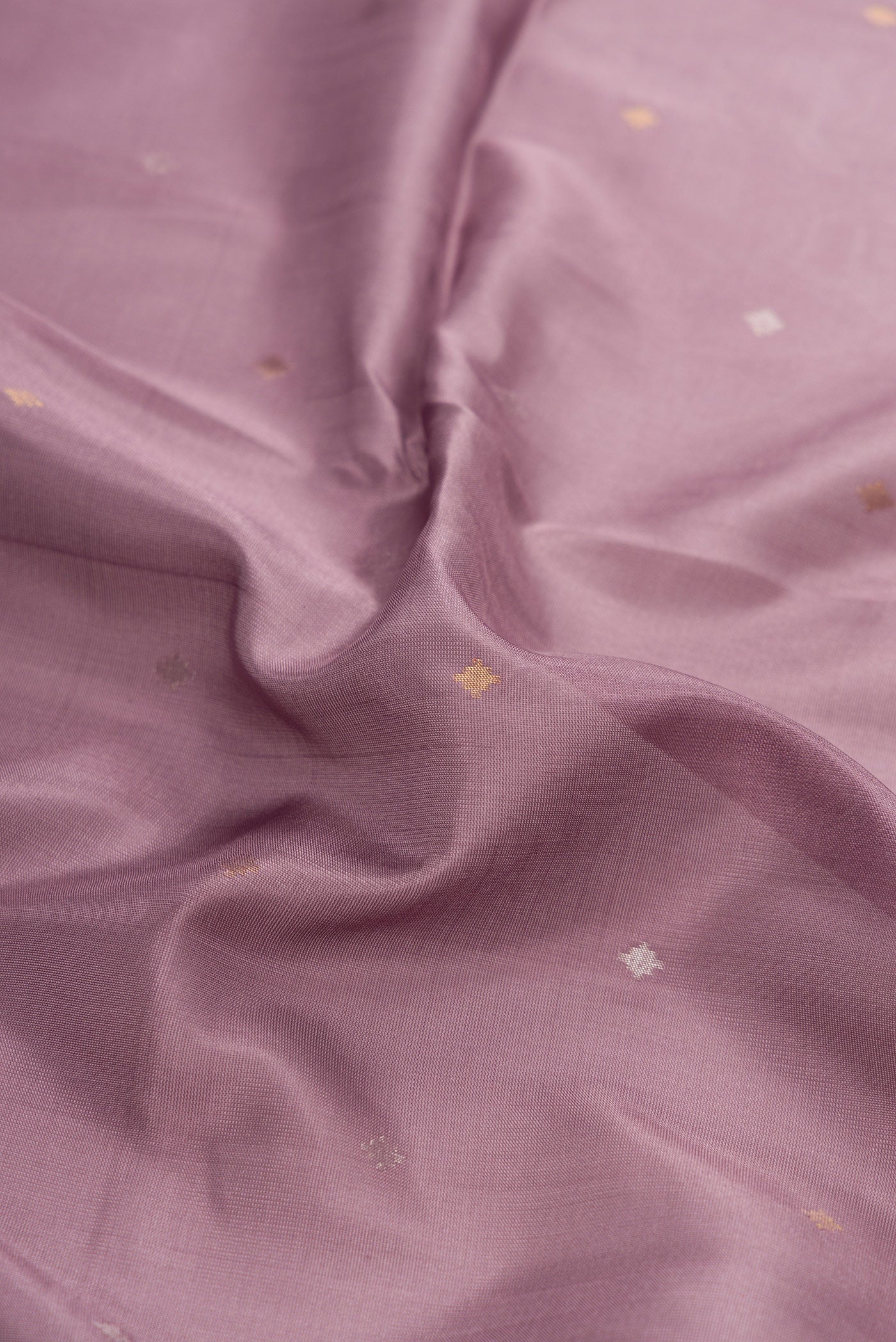 Close up of Brown Dual Tone Uppada Silk Saree with Zari Butta on the body and Zari Border.  displaying folds