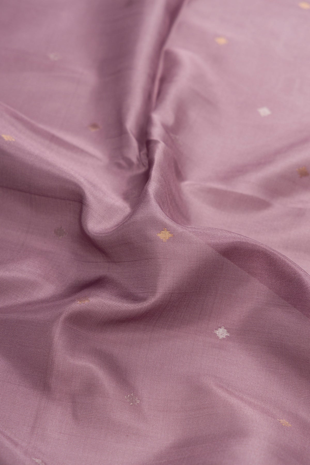 Close up of Brown Dual Tone Uppada Silk Saree with Zari Butta on the body and Zari Border.  displaying folds