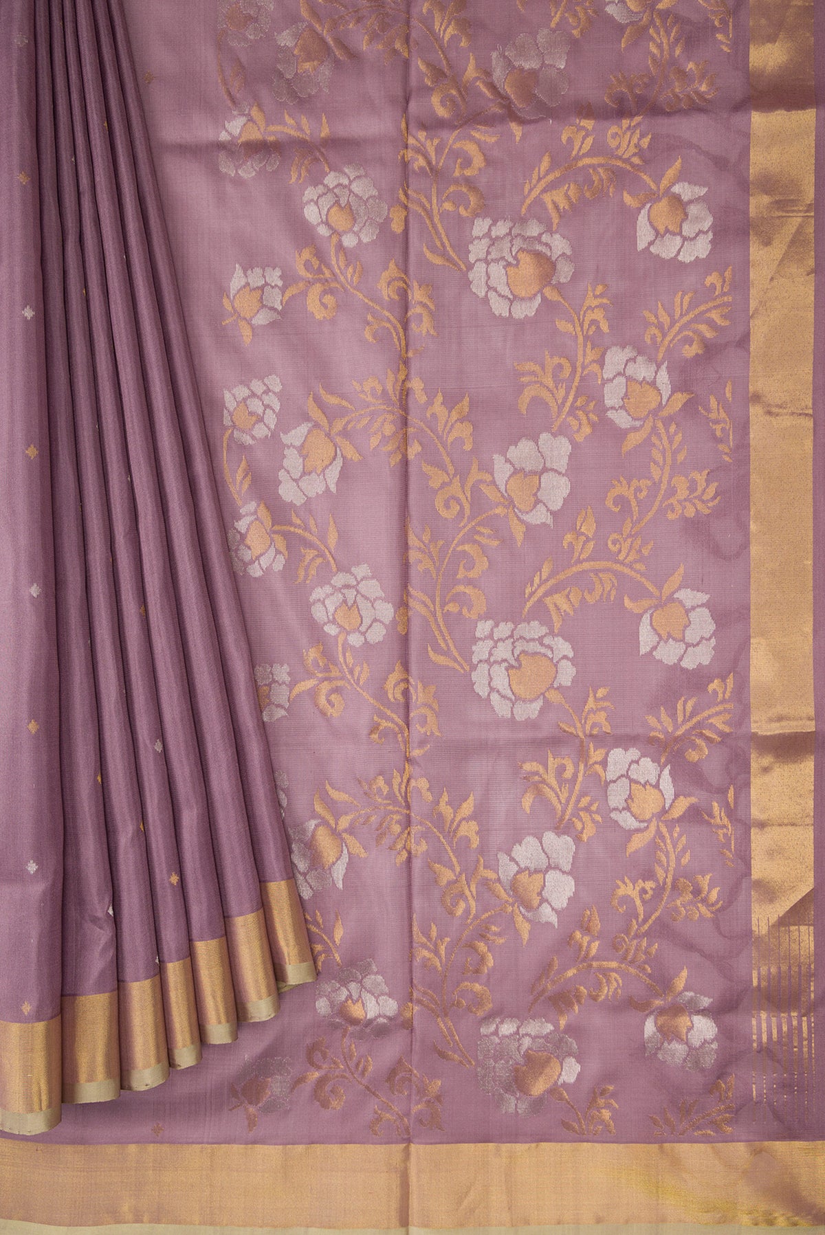 Pleats and pallu of Brown Dual Tone Uppada Silk Saree with Zari Butta on the body and Zari Border. 