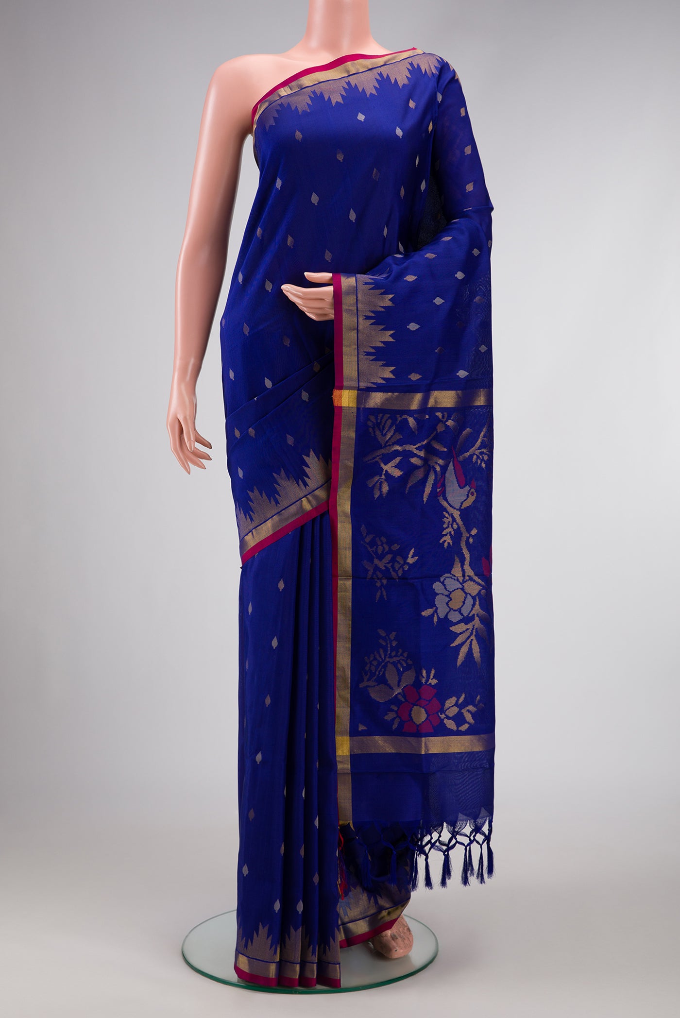 Navy Blue Dual Tone Uppada Silk Saree with Zari Butta on the body and Temple Border.  displayed on a mannequin