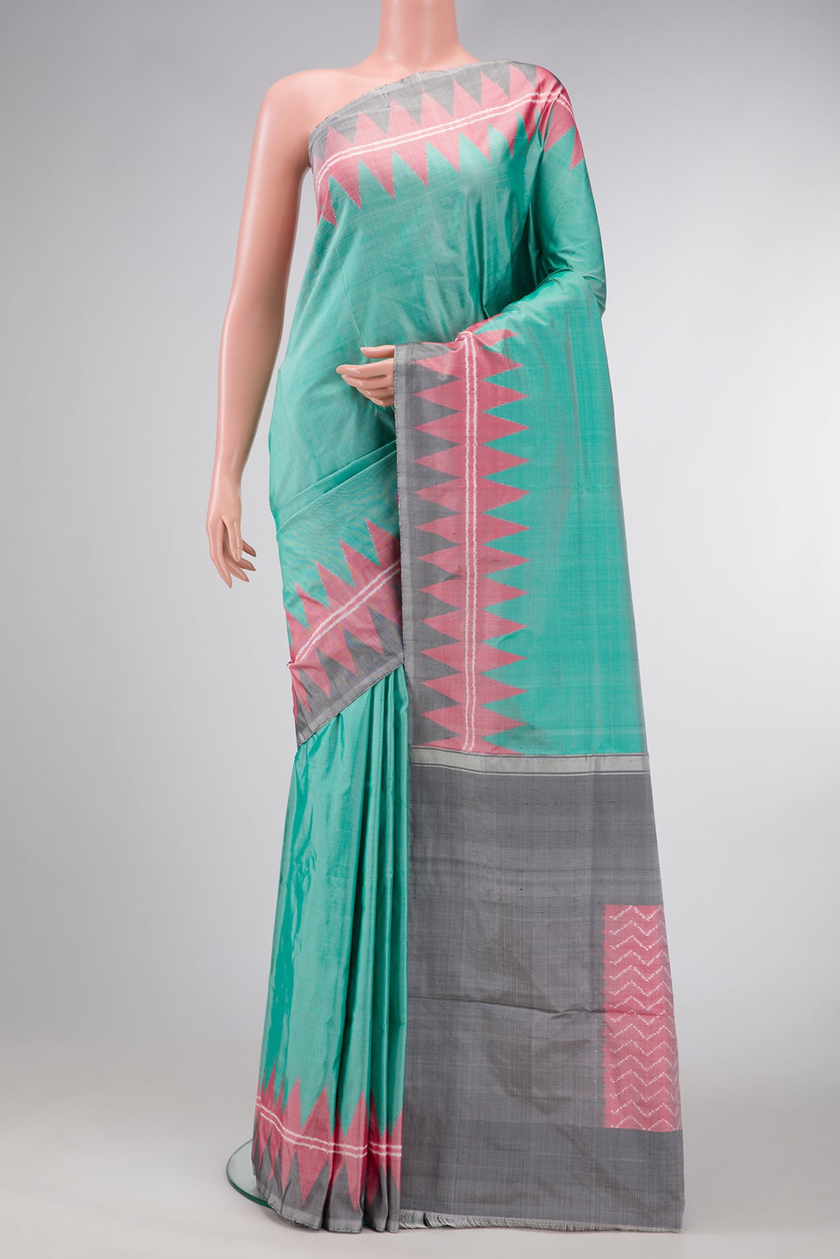 Green Dual Tone Double Ikat Saree with Plain Body and Temple Border.  displayed on a mannequin