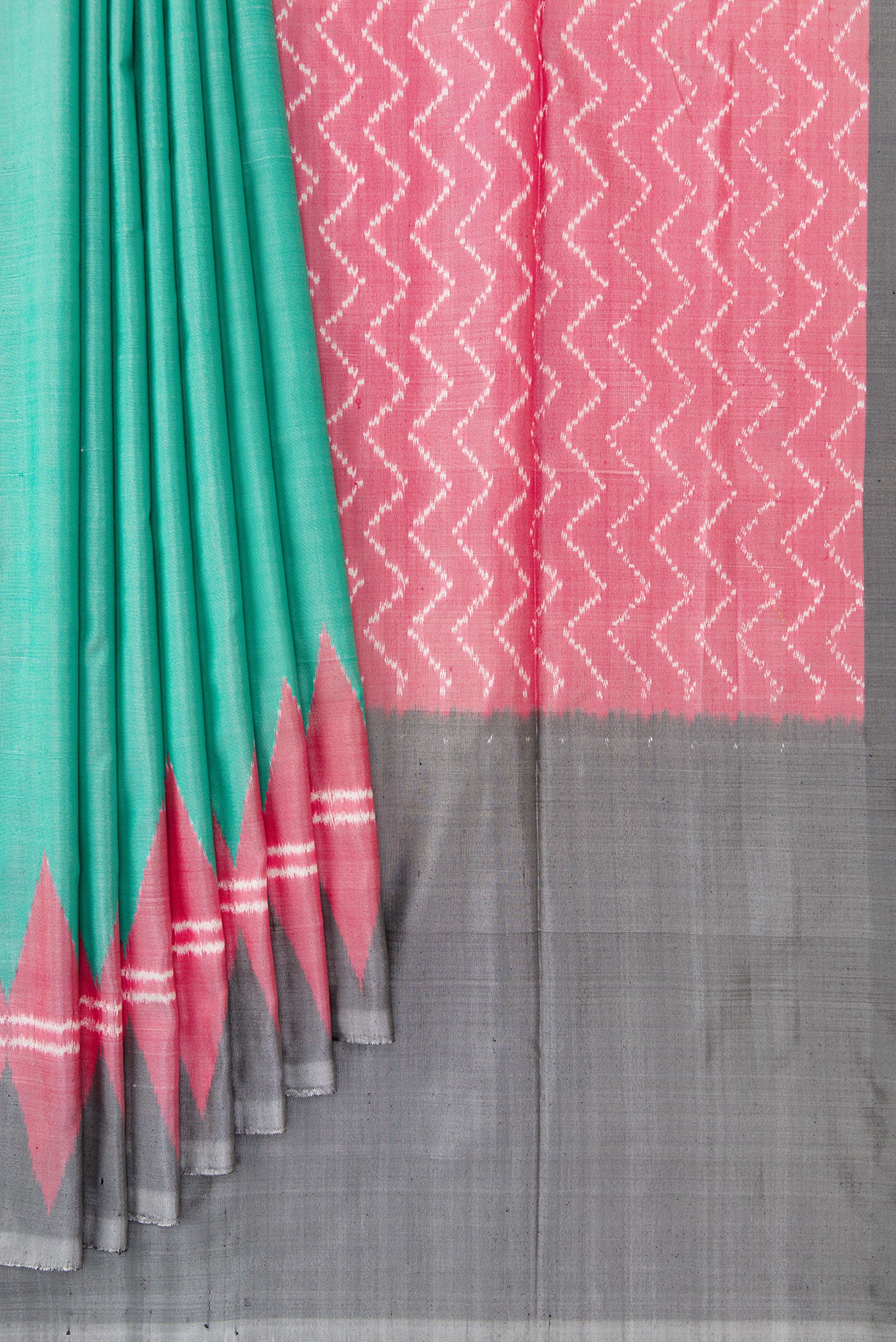 Pleats and pallu of Green Dual Tone Double Ikat Saree with Plain Body and Temple Border. 