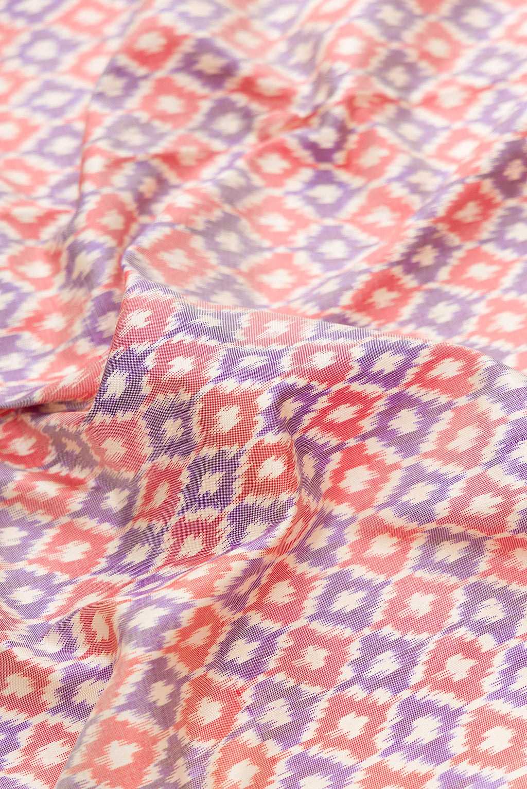 Close up of Lilac Dual Tone Double Ikat Saree with Ikat Print on the body and Zari Border.  displaying folds