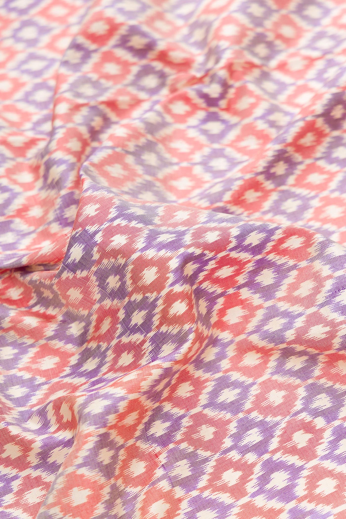 Close up of Lilac Dual Tone Double Ikat Saree with Ikat Print on the body and Zari Border.  displaying folds