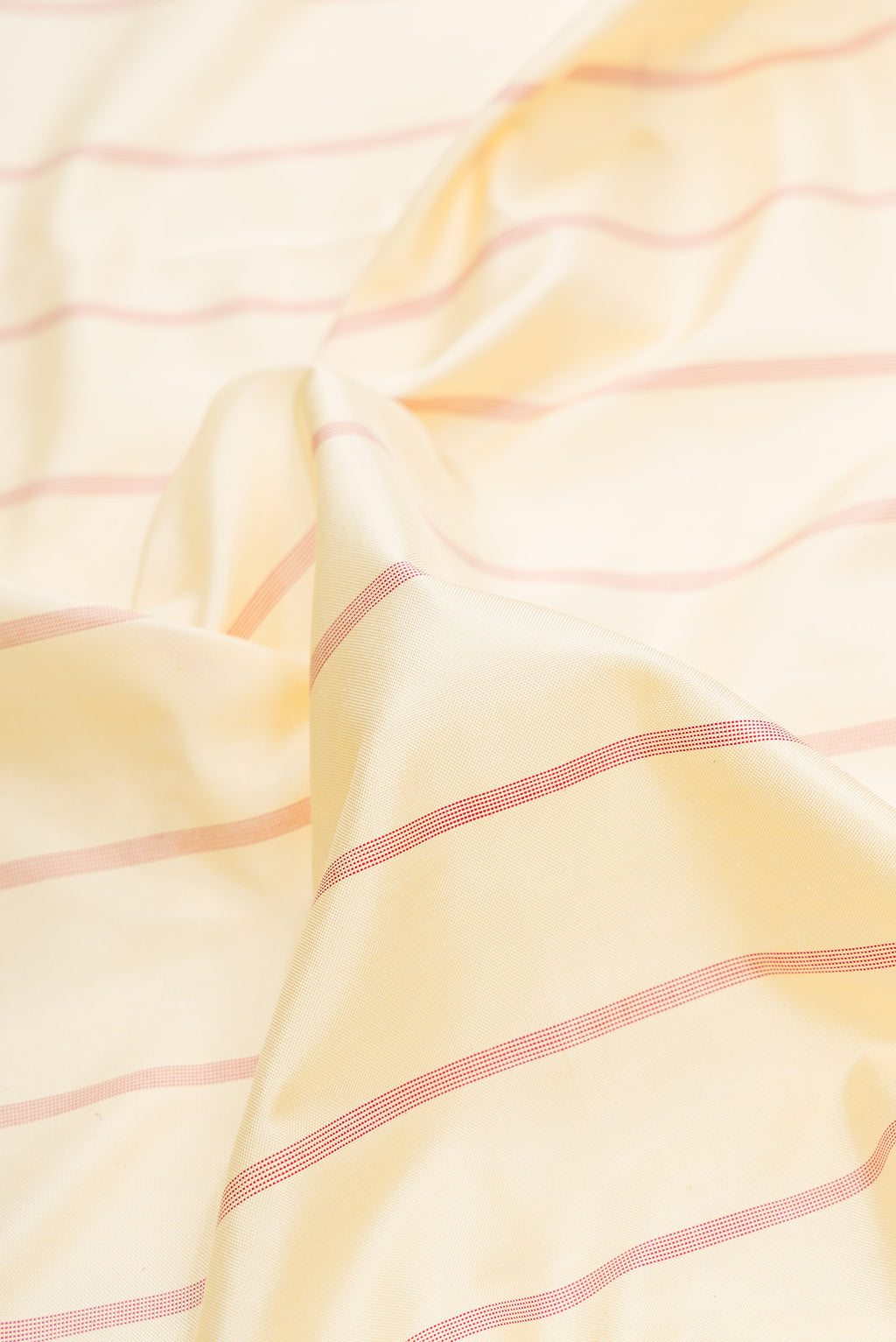Close up of Sandal Dual Tone Double Ikat Saree with Stripes on the body and Ikat Border.  displaying folds