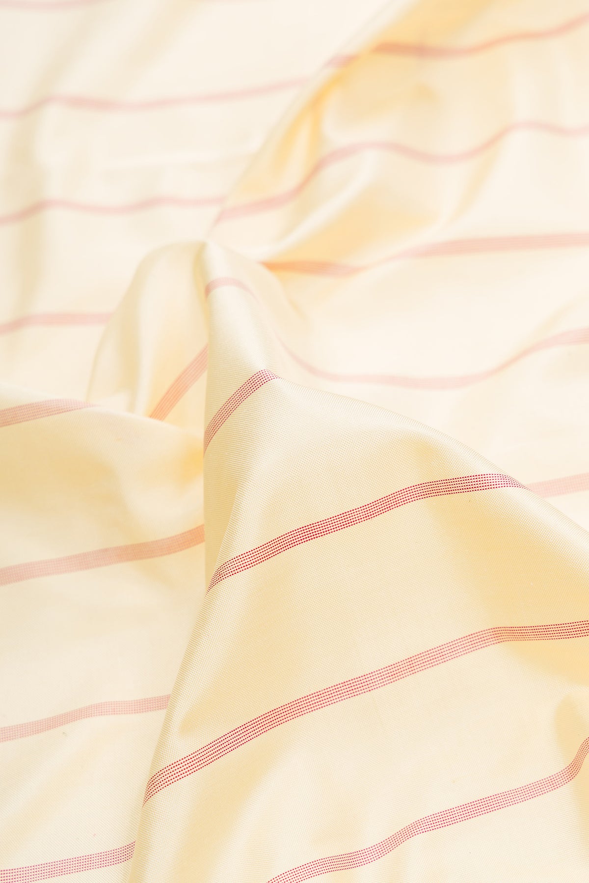 Close up of Sandal Dual Tone Double Ikat Saree with Stripes on the body and Ikat Border.  displaying folds