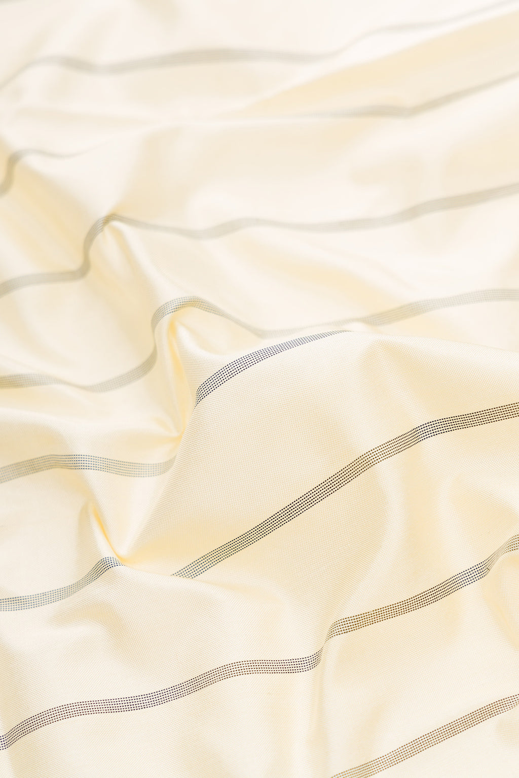 Close up of Sandal Dual Tone Double Ikat Saree with Stripes on the body and Ikat Border.  displaying folds