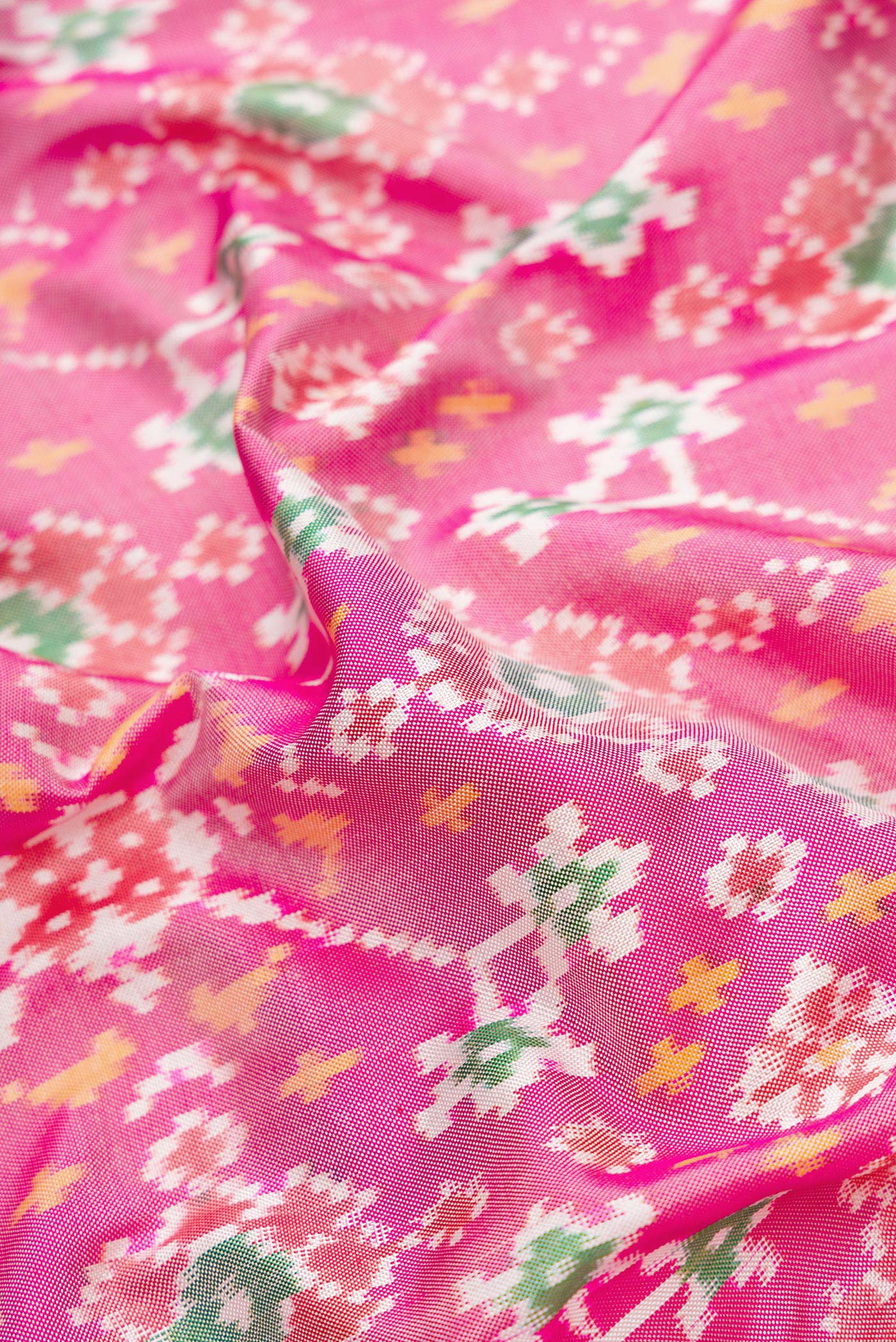 Close up of Pink Dual Tone Double Ikat Saree with Ikat Print on the body and Ikat Border.  displaying folds