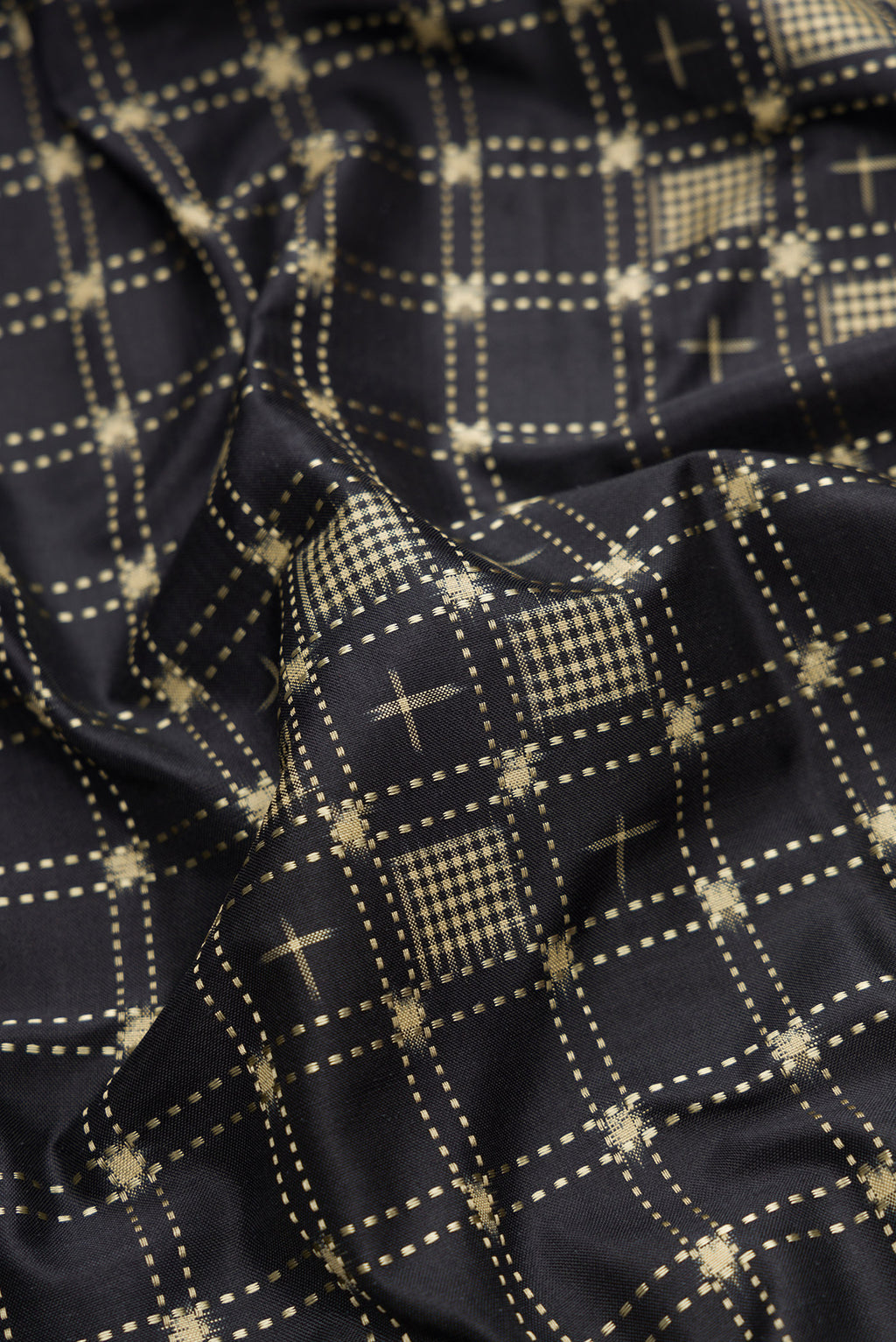 Close up of Black Dual Tone Banarasi Silk Saree with Zari Butta on the body and Zari Border.  displaying folds