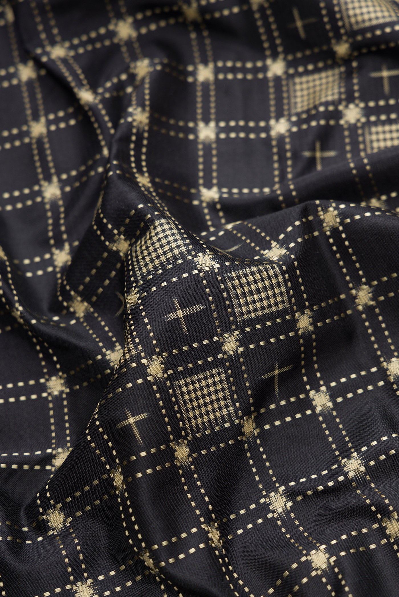 Close up of Black Dual Tone Banarasi Silk Saree with Zari Butta on the body and Zari Border.  displaying folds