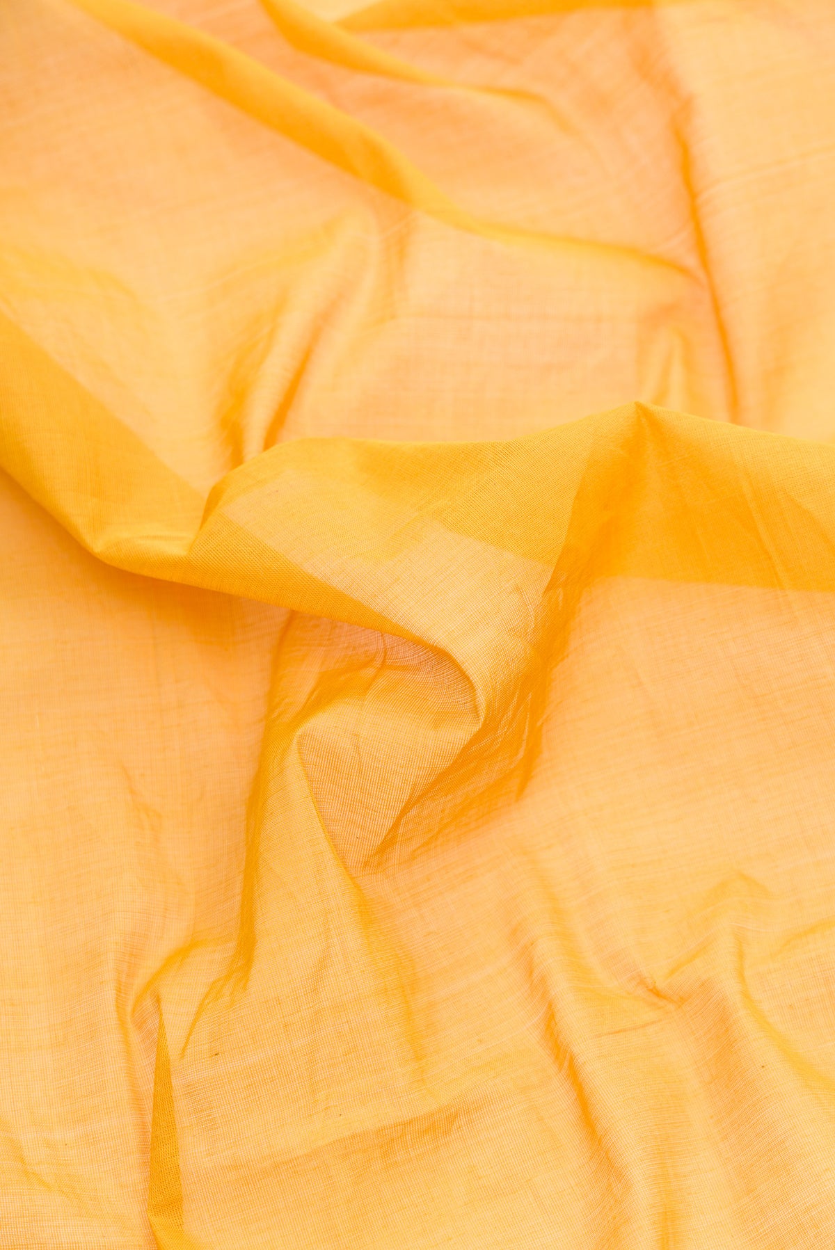 Close up of Mustard Dual Tone Kota Cotton Saree with Plain Body and Temple Border.  displaying folds