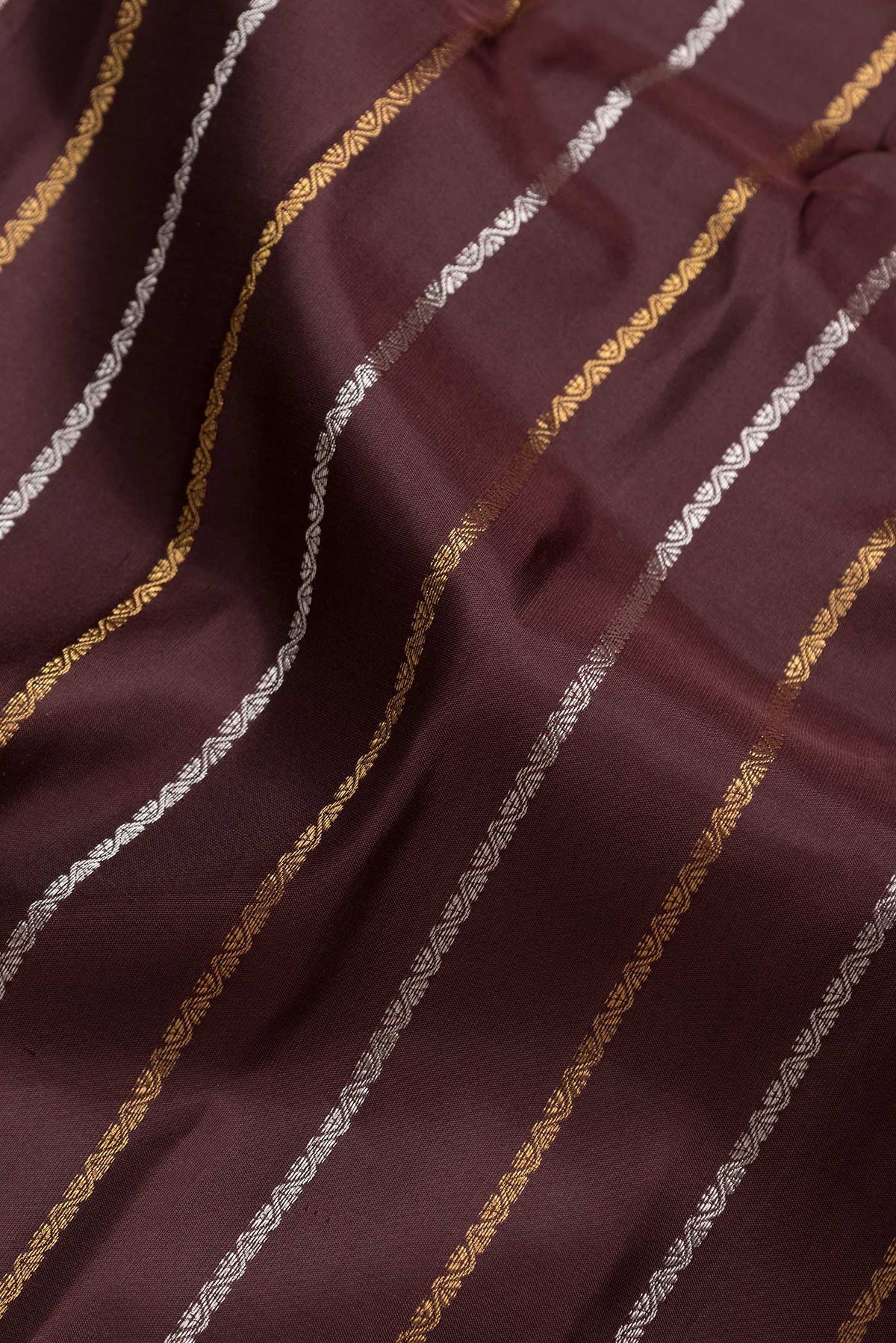 Close up of Brown Dual Tone Gadwal Silk Saree with Stripes on the body and Zari Border.  displaying folds