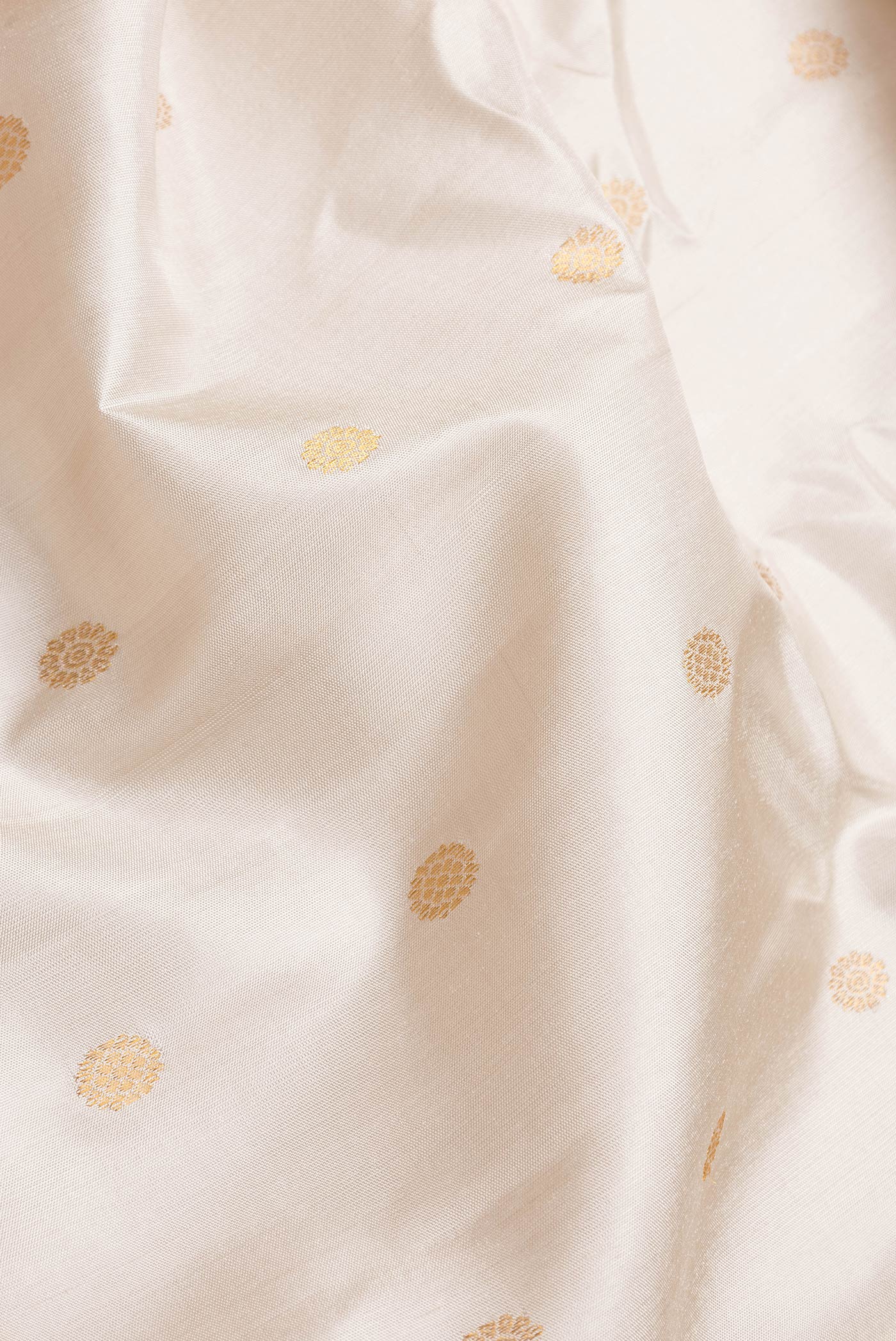Close up of Beige Dual Tone Gadwal Silk Saree with Zari Butta on the body and Zari Border.  displaying folds