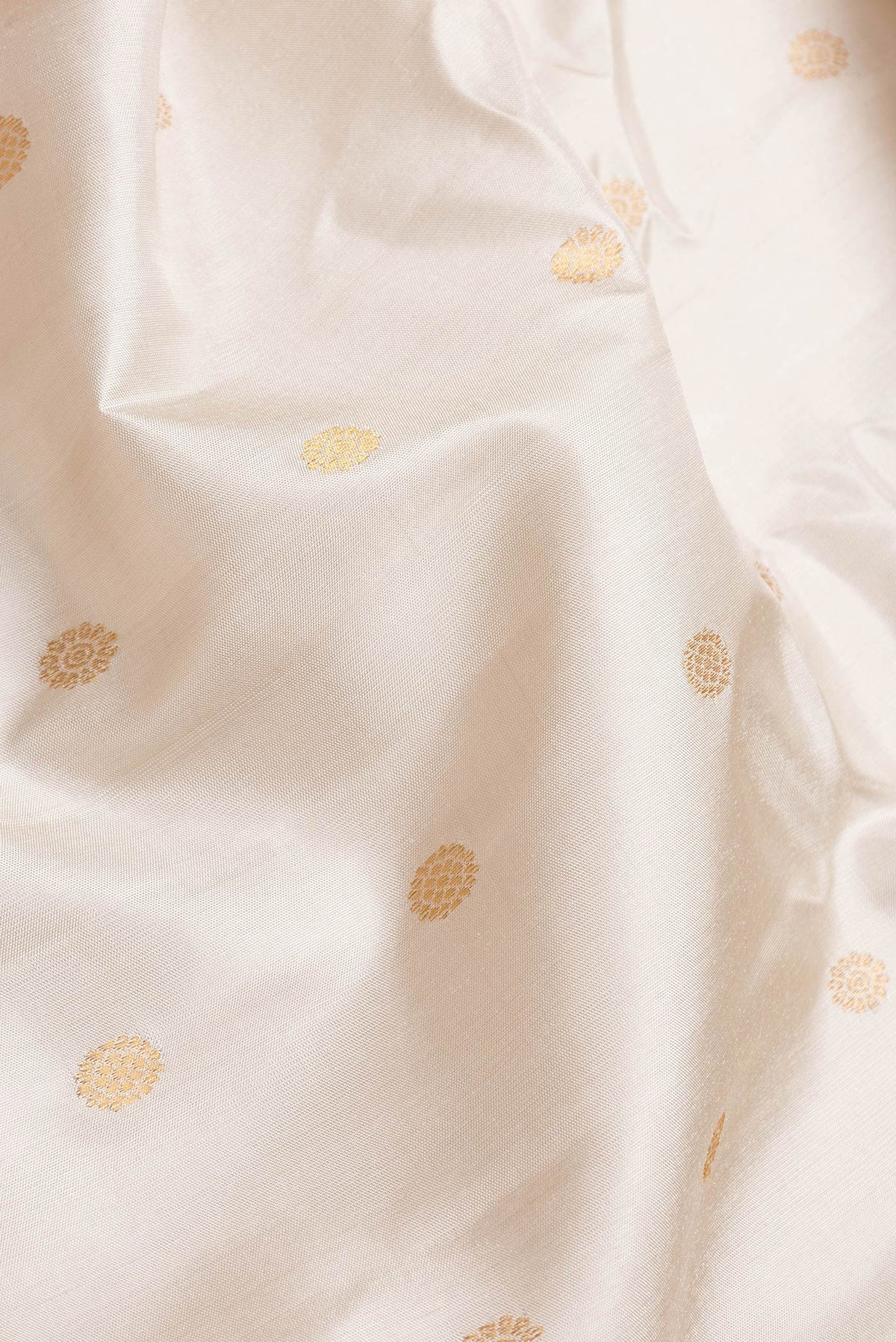 Close up of Beige Dual Tone Gadwal Silk Saree with Zari Butta on the body and Zari Border.  displaying folds