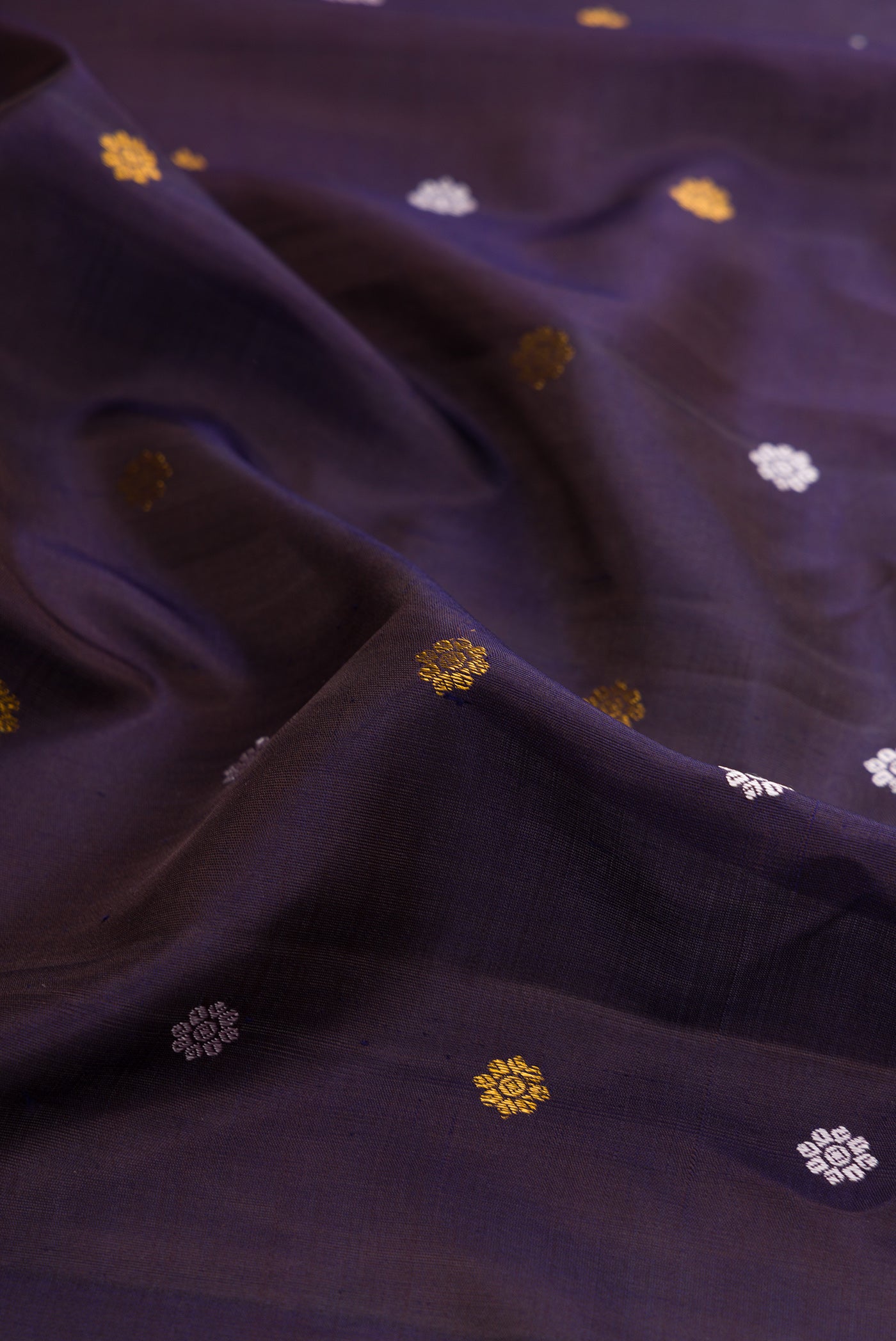 Close up of Navy Blue Dual Tone Gadwal Silk Saree with Zari And Thread Butta on the body and Zari Border.  displaying folds