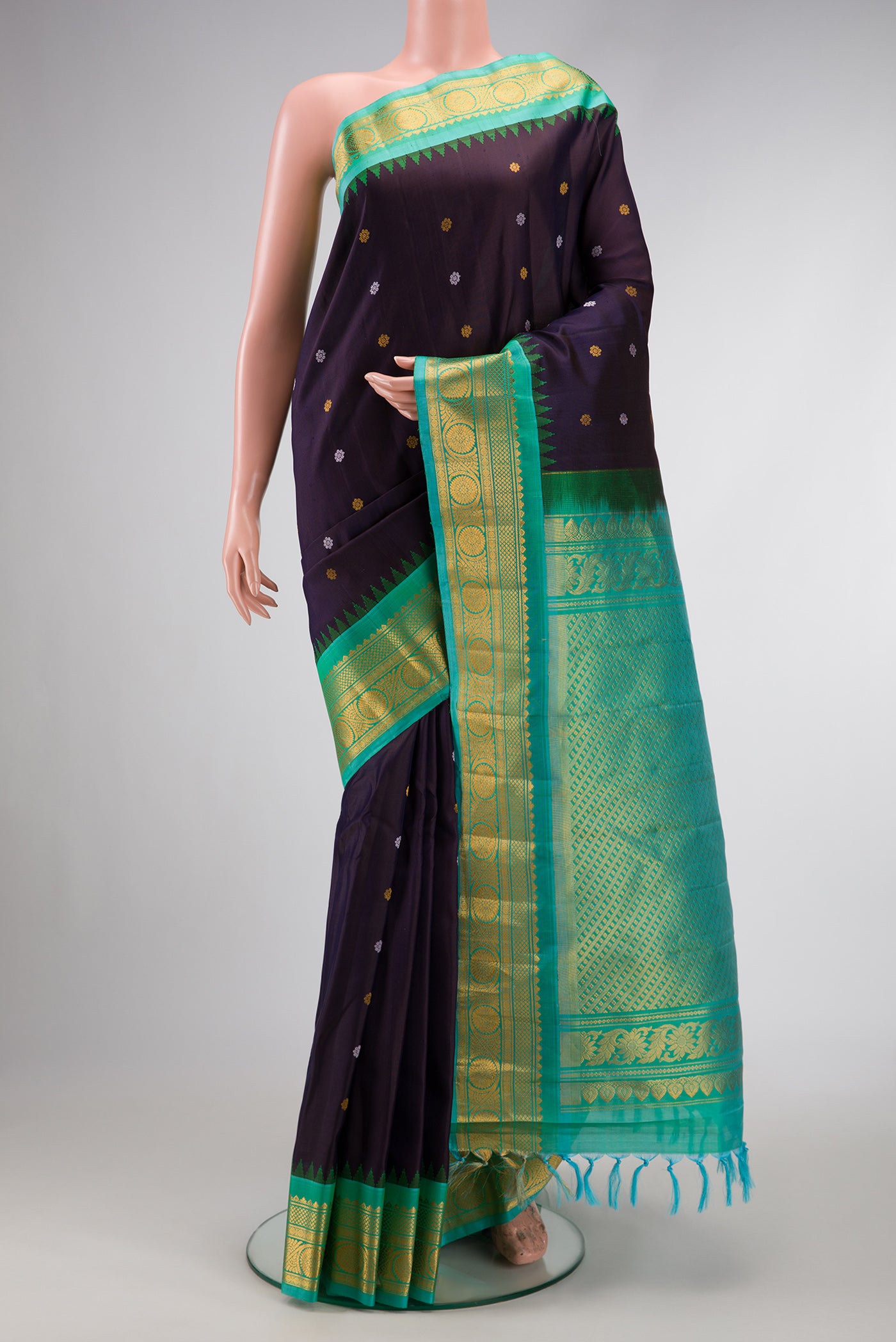 Navy Blue Dual Tone Gadwal Silk Saree with Zari And Thread Butta on the body and Zari Border.  displayed on a mannequin